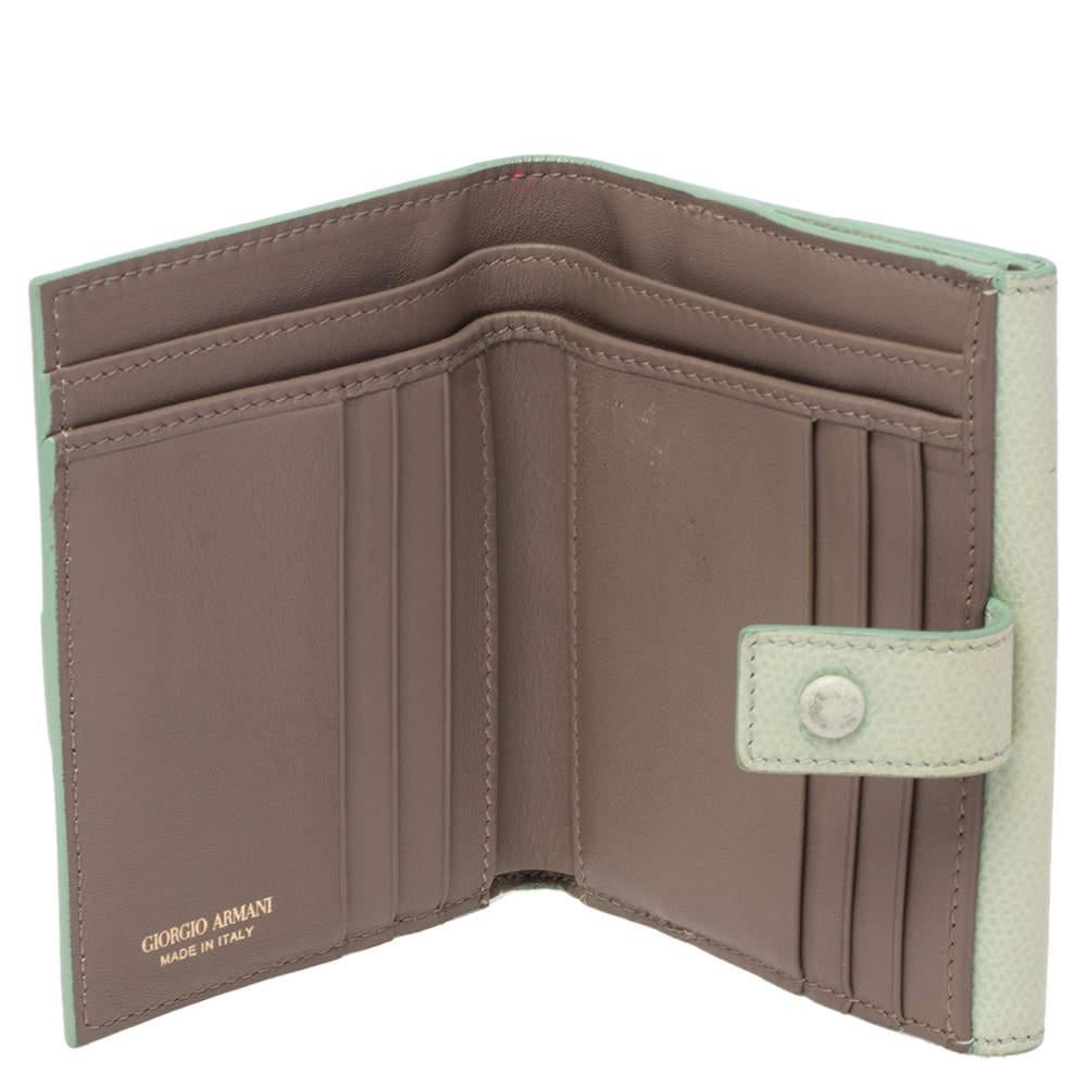 This cute elegant green French wallet by Giorgio Armani will be your go to accessory in no time The leather and nylon interior of this wallet is neatly structured and will make a safe home for your currency and other items.
