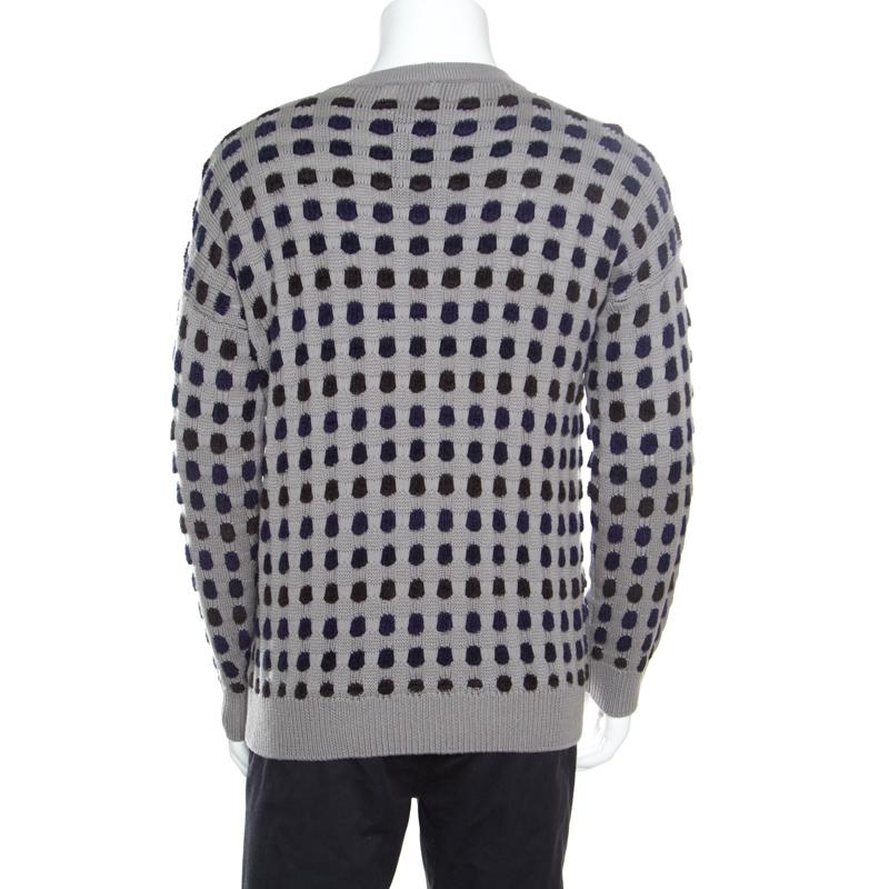 From the exclusive collection of Giorgio Armani, this sweater flaunts the uniqueness in classic styling. Crafted in a wool blend, the grey sweater has the dotted accents all over its silhouette. The loose fitted sweater features ribbed neckline,
