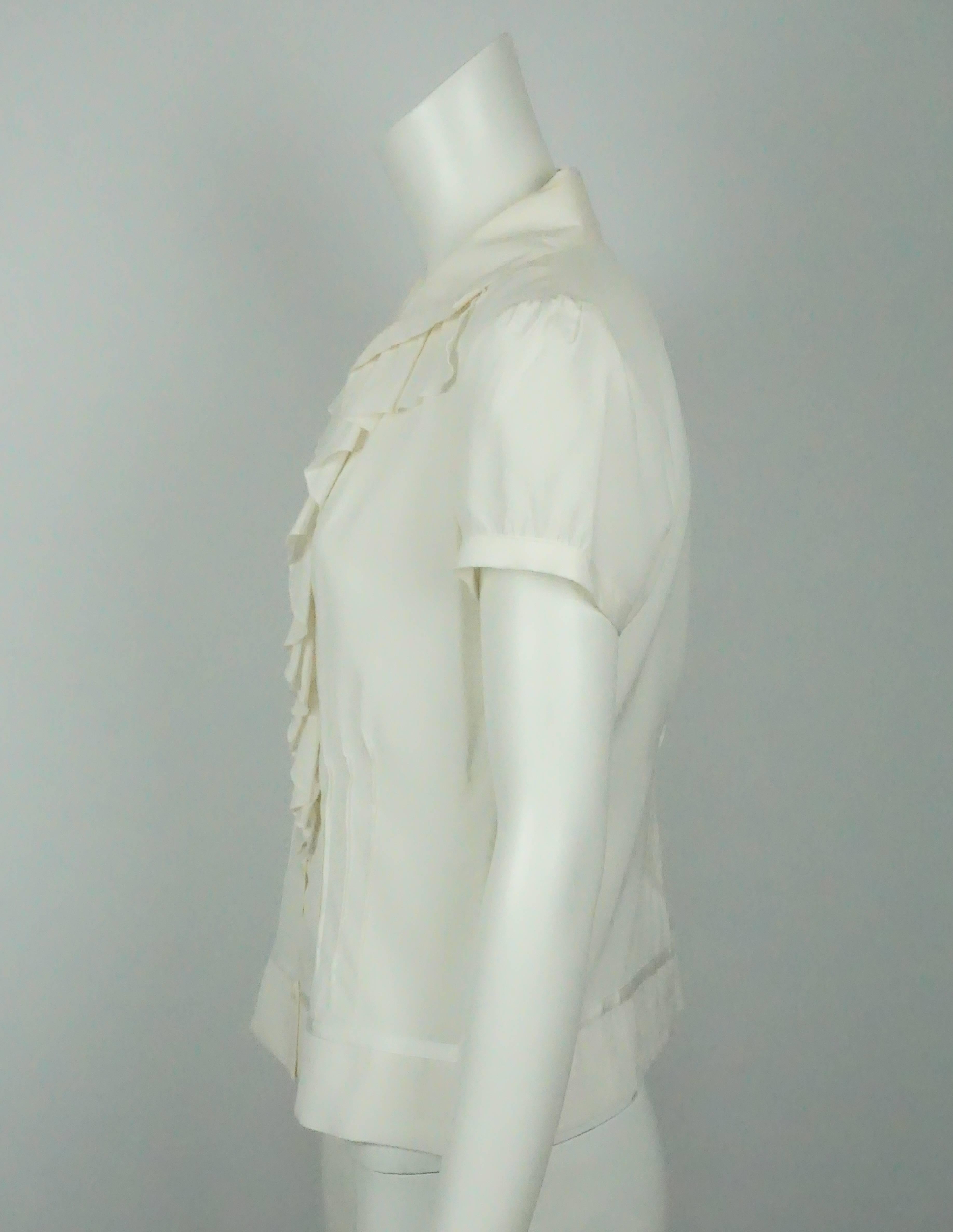 Giorgio Armani Ivory Silk S/S w/ Ruffles Top - NWT - 8  This classic silk top is in excellent condition. The front of the top has a ruffle detail that starts from under the collar and goes almost all the way down to the bottom of the top. There are