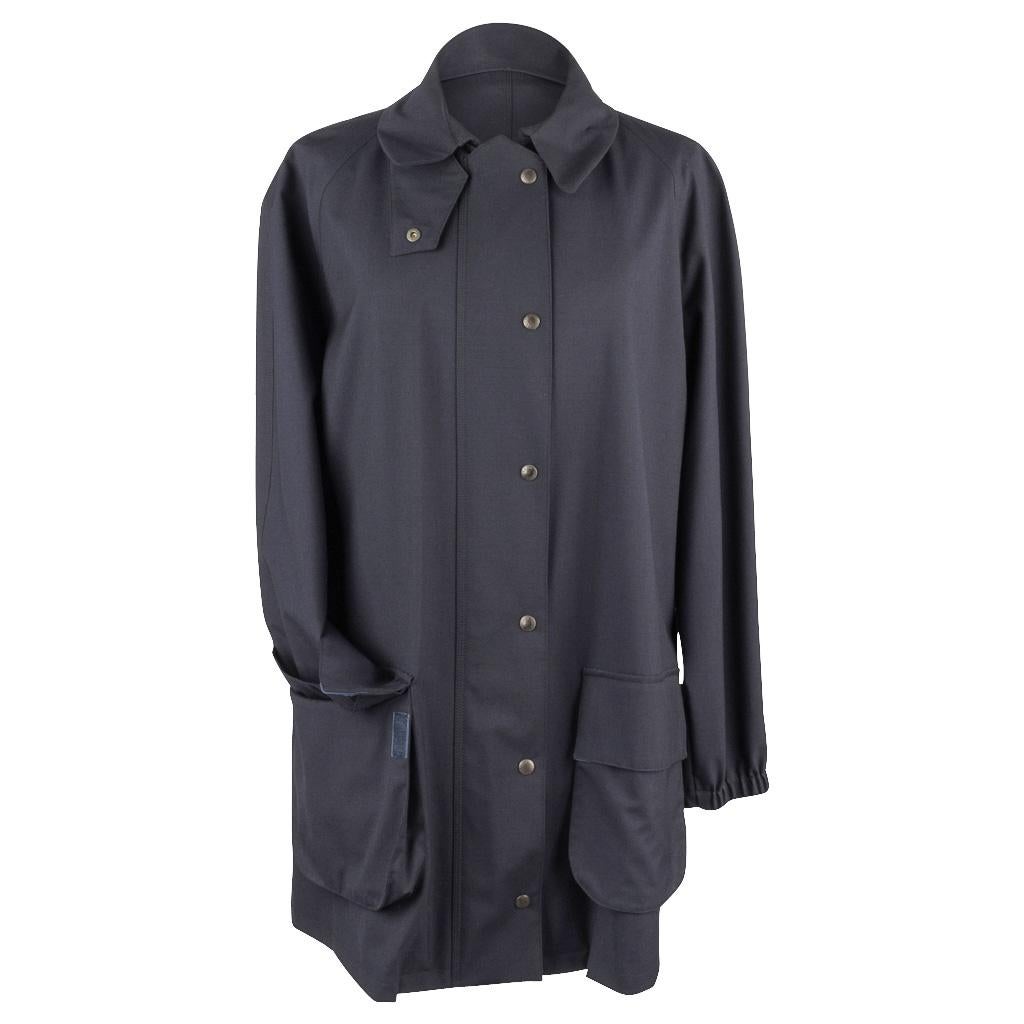 Guaranteed authentic Giorgio Armani navy blue jacket with Loro Piana storm system fabric.
Terrific styling to this hidden zip front windbreaker jacket.
Pure Americana in dark navy blue with a small collar that has a snap placquet to wear up.
6