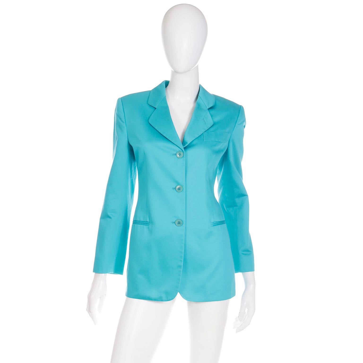 This lovely vintage Giorgio Armani Le Collezioni aqua blue blazer style jacket is so versatile and easy to wear. The longline jacket buttons in front and a has a notched lapel. Designed with Armani's signature clean lines in a minimalist and