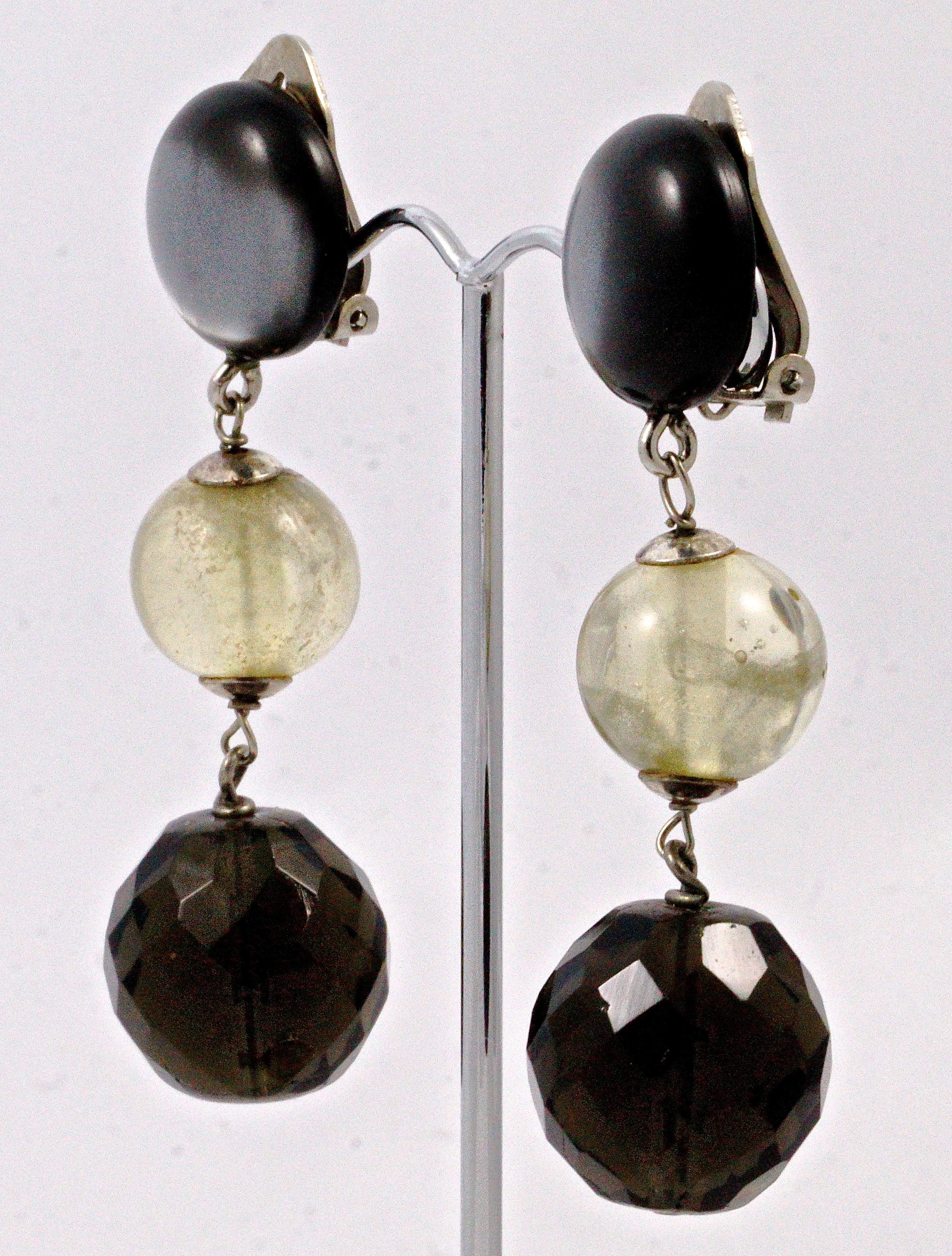 Lovely Giorgio Armani clip on drop earrings, featuring round green tinted balls and smoky green faceted glass stones hanging from contrasting grey moonglow tops. Measuring drop 6.5cm / 2.56 inches.

This is an unusual pair of vintage drop earrings