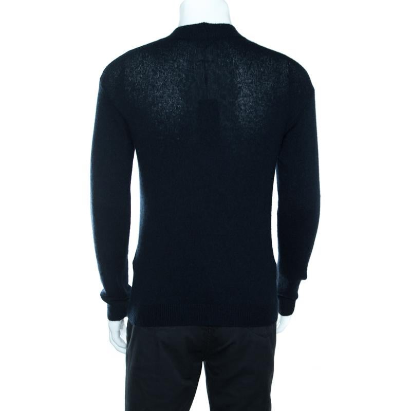 Stay warm and stylish at the same time in this fabulous sweater from Giorgio Armani. This navy blue sweater is made of a cashmere and silk blend and features a crisp fitting. It flaunts a high neck and long sleeves. Pair it with denims and smart
