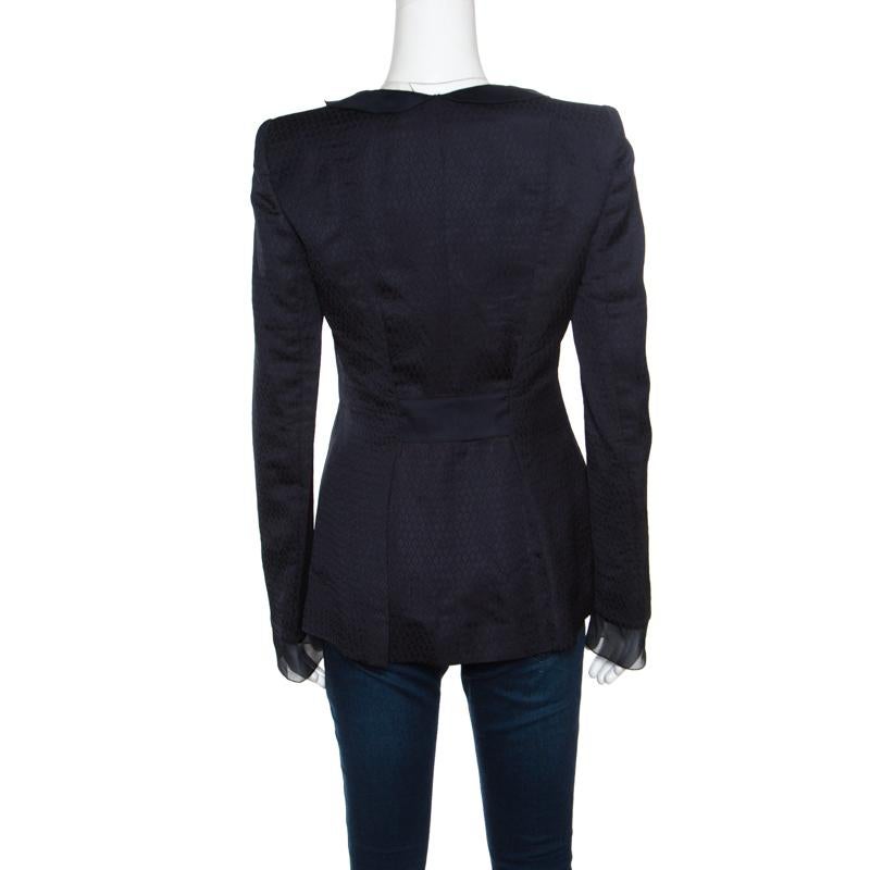 Elevate your jacket collection with this one from Giorgio Armani. This navy blue coat is made of quality fabrics and it flaunts long sleeves, organza trims and three buttons. This creation is just perfect to nail a stylish look.

