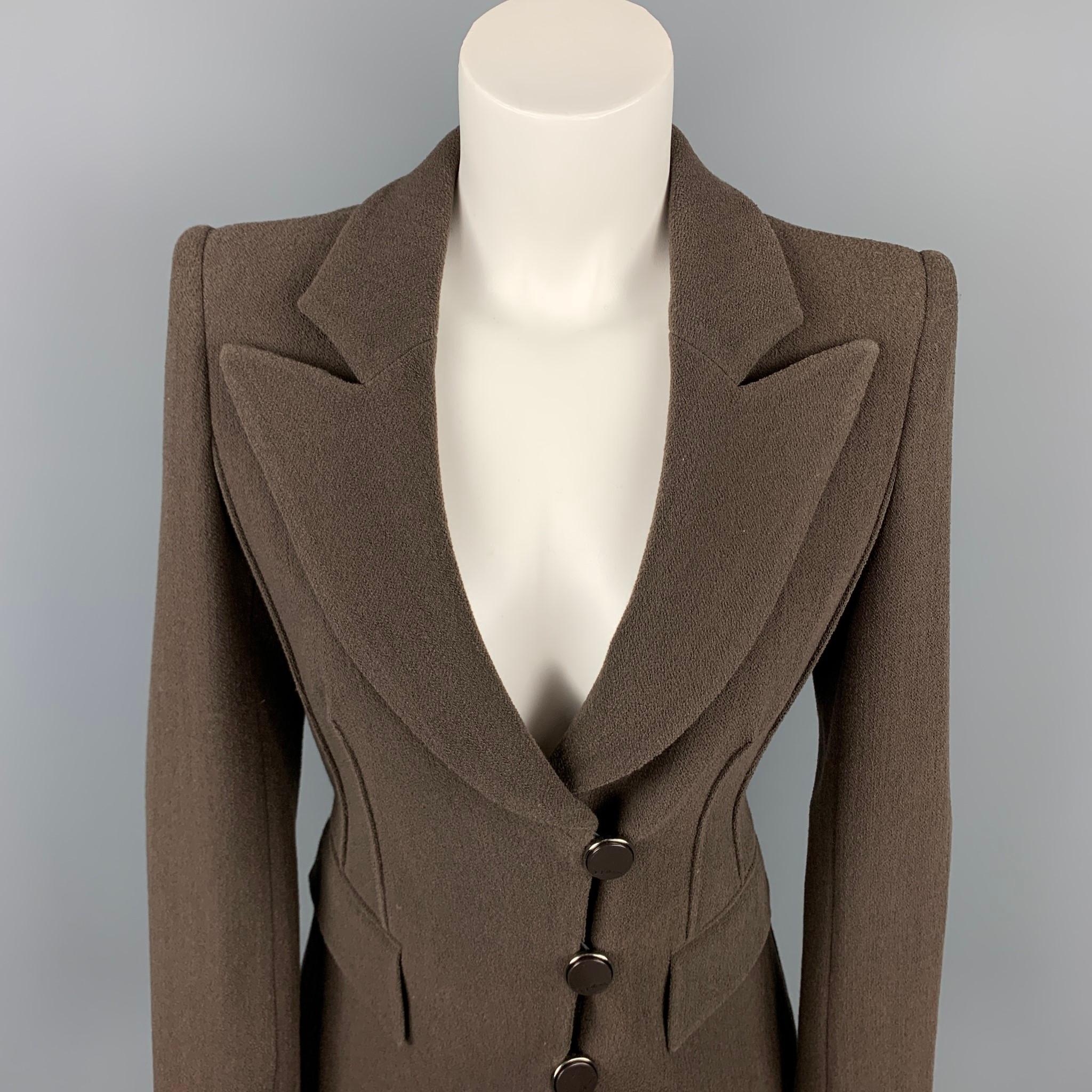 GIORGIO ARMANI blazer comes in a brown crepe wool blend with a full liner featuring a peak lapel, flap pockets, and a buttoned closure. Made in Italy.

Very Good Pre-Owned Condition.
Marked: IT 36

Measurements:

Shoulder: 16 in.
Bust: 36