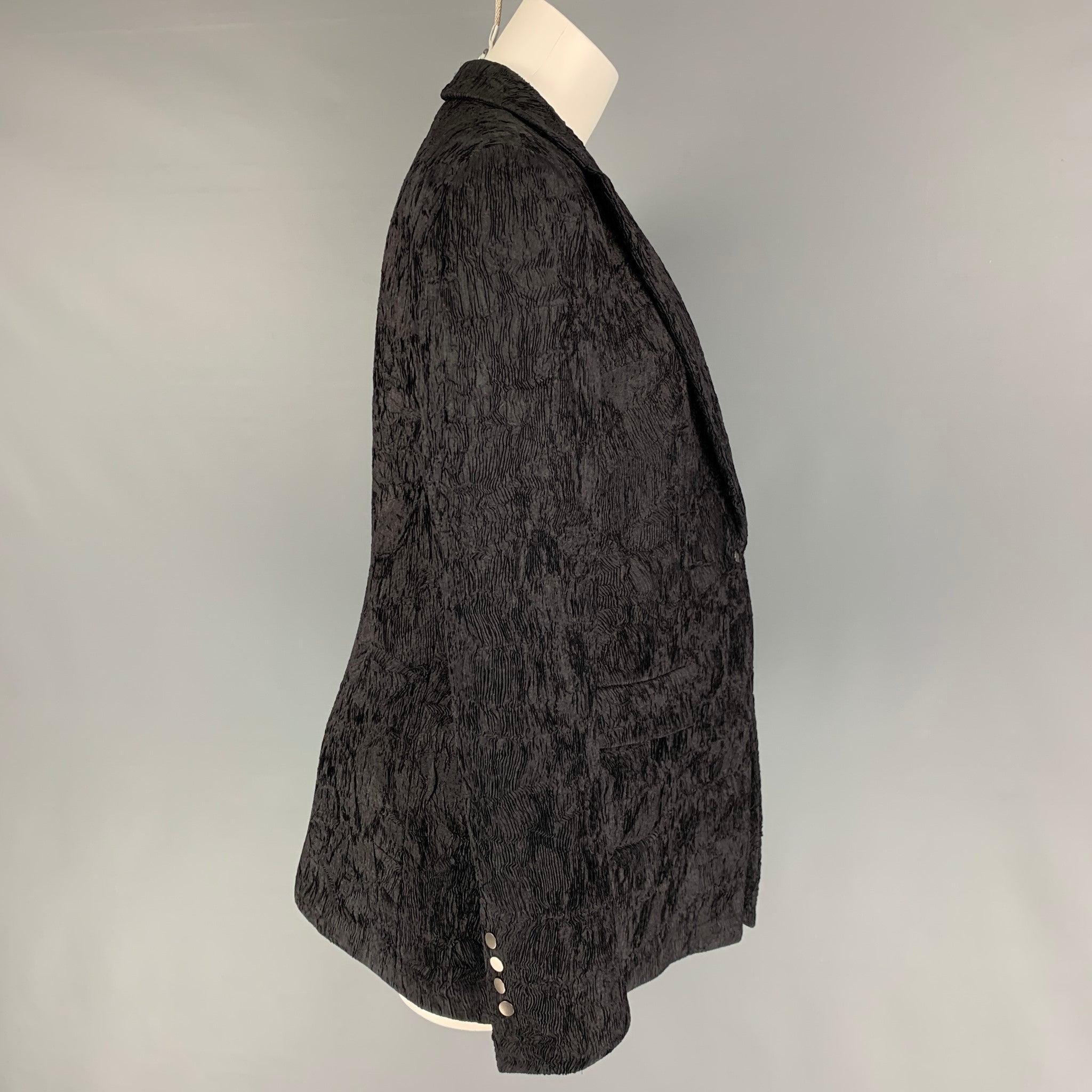GIORGIO ARMANI jacket comes in a black textured silk / viscose featuring a notch lapel, flap pockets, single back vent, and a single button closure. Made in Italy.
Very Good
Pre-Owned Condition. 

Marked:   46 

Measurements: 
 
Shoulder: 17 inches 