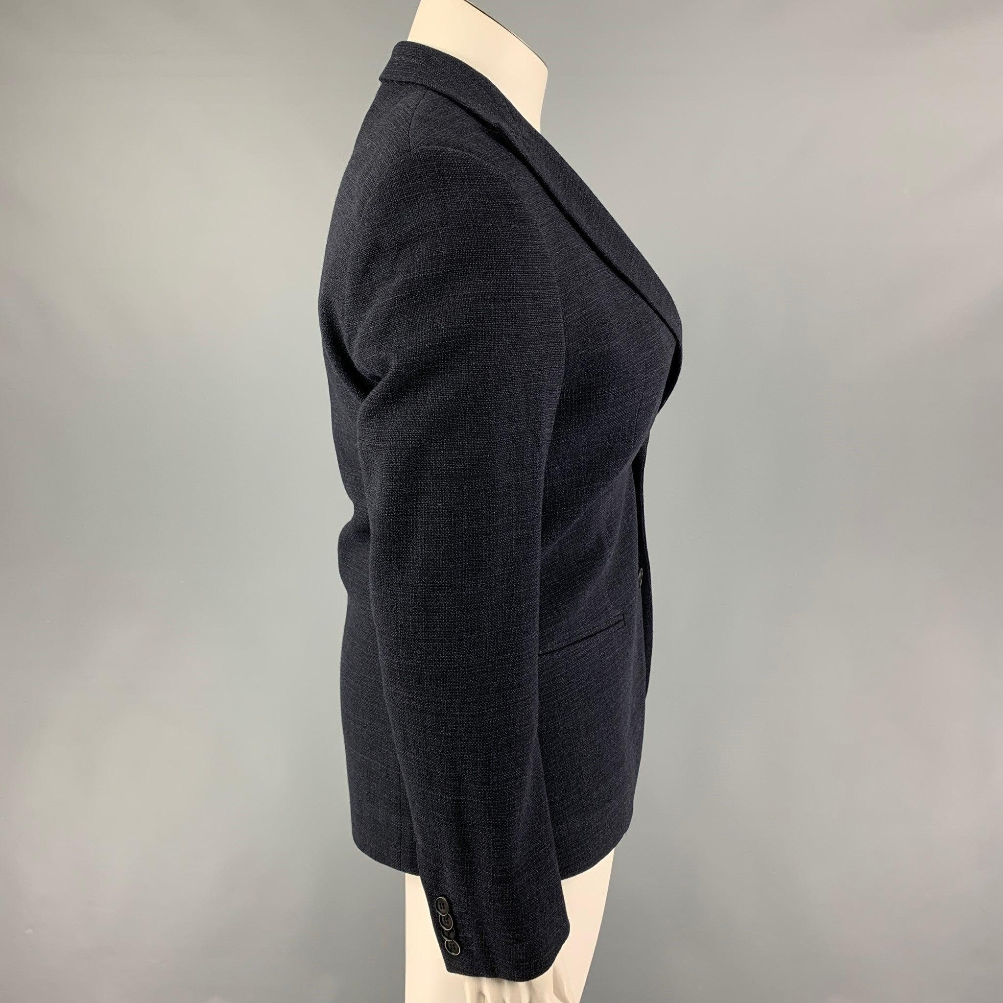 GIORGIO ARMANI blazer comes in a navy wool with a full liner featuring a peak lapel, slit pockets, and a double button closure.
Excellent
Pre-Owned Condition. 

Marked:   46 

Measurements: 
 
Shoulder: 17 inches Bust: 36 inches Sleeve: 25.5 inches