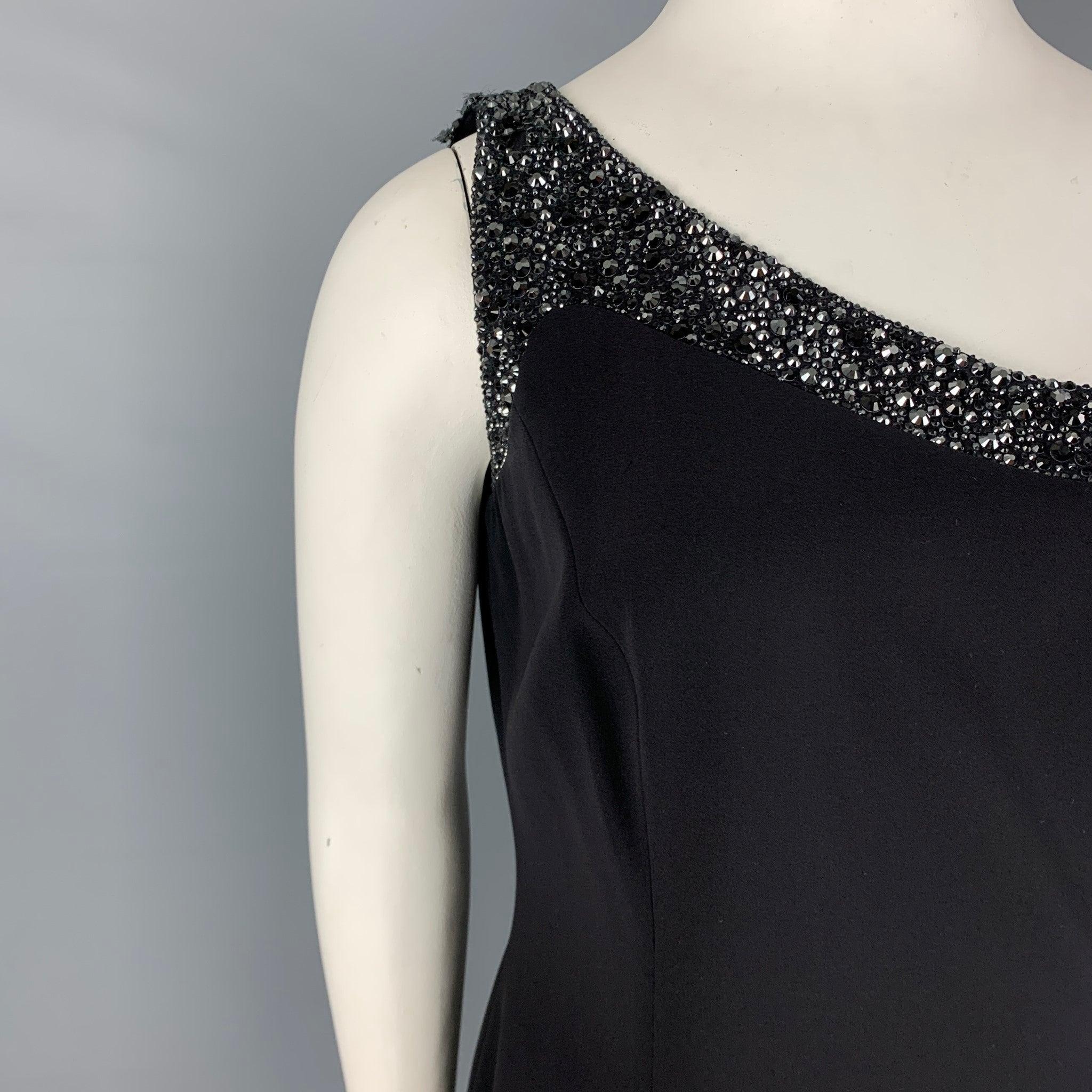 GIORGIO ARMANI dress comes in a black material featuring a rhinestone trim design, wrap style, slit pockets, and a side zipper closure. Made in Italy.
Very Good Pre-Owned Condition. Moderate wear at shoulder. As-is.  

Marked:   48 

Measurements: 

