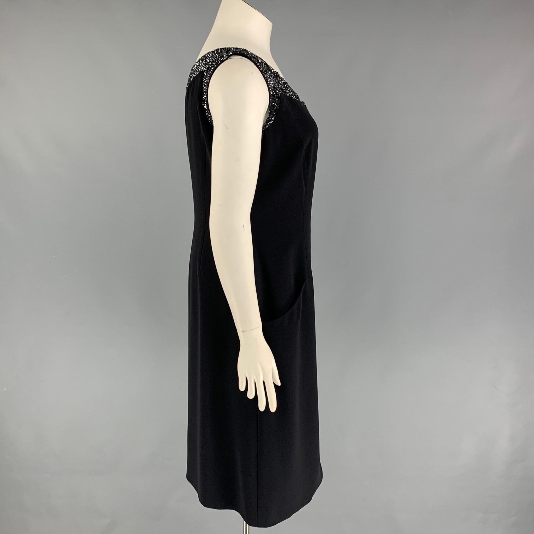 GIORGIO ARMANI dress comes in a black material featuring a rhinestone trim design, wrap style, slit pockets, and a side zipper closure. Made in Italy. 

Very Good Pre-Owned Condition.
Marked: 48

Measurements:

Bust: 37 in.
Waist: 34 in.
Hip: 38