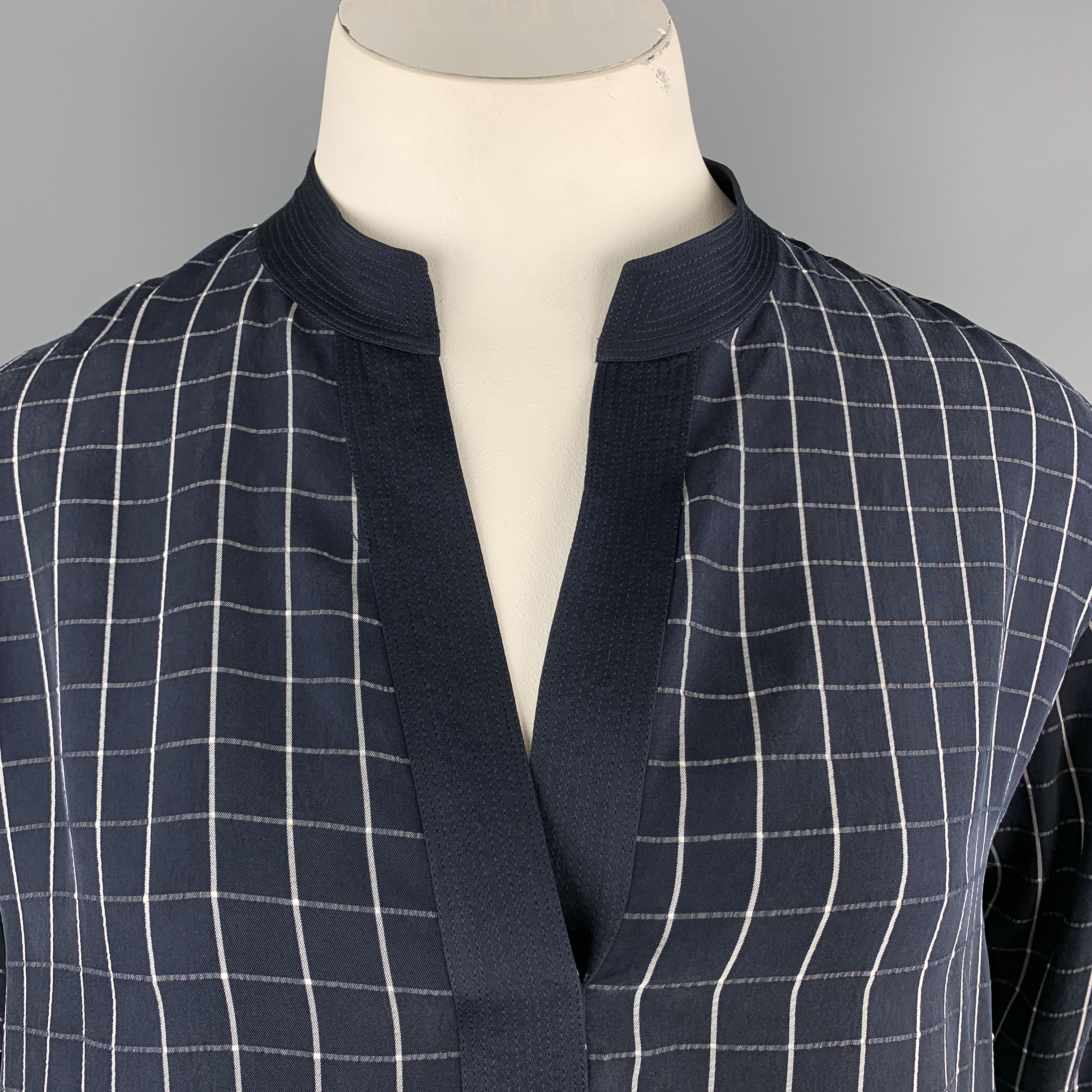 GIORGIO ARMANI blouse comes in navy and white windowpane fabric with a quilted satin trim V neck and three quarter sleeves. Made in Italy.

Excellent Pre-Owned Condition.
Marked: IT 48

Measurements:

Shoulder: 18 in.
Bust: 42 in.
Sleeve: 16.5