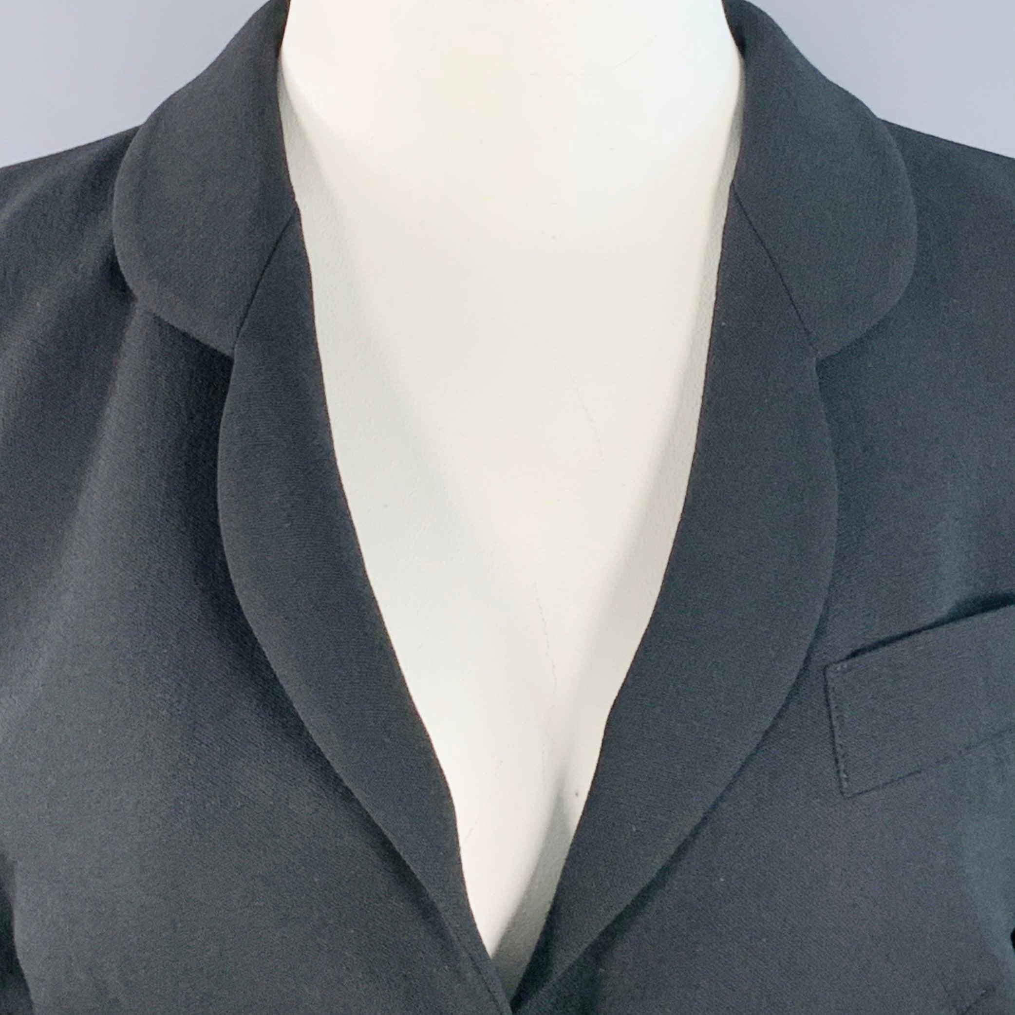 GIORGIO ARMANI blazer
in a
black wool featuring a rounded notch lapel, ventless back, and double button closure. Made in Italy.Very Good Pre-Owned Condition. Minor tear on shoulder. 

Marked:   48/14 

Measurements: 
 
Shoulder: 16.75 inches Bust: