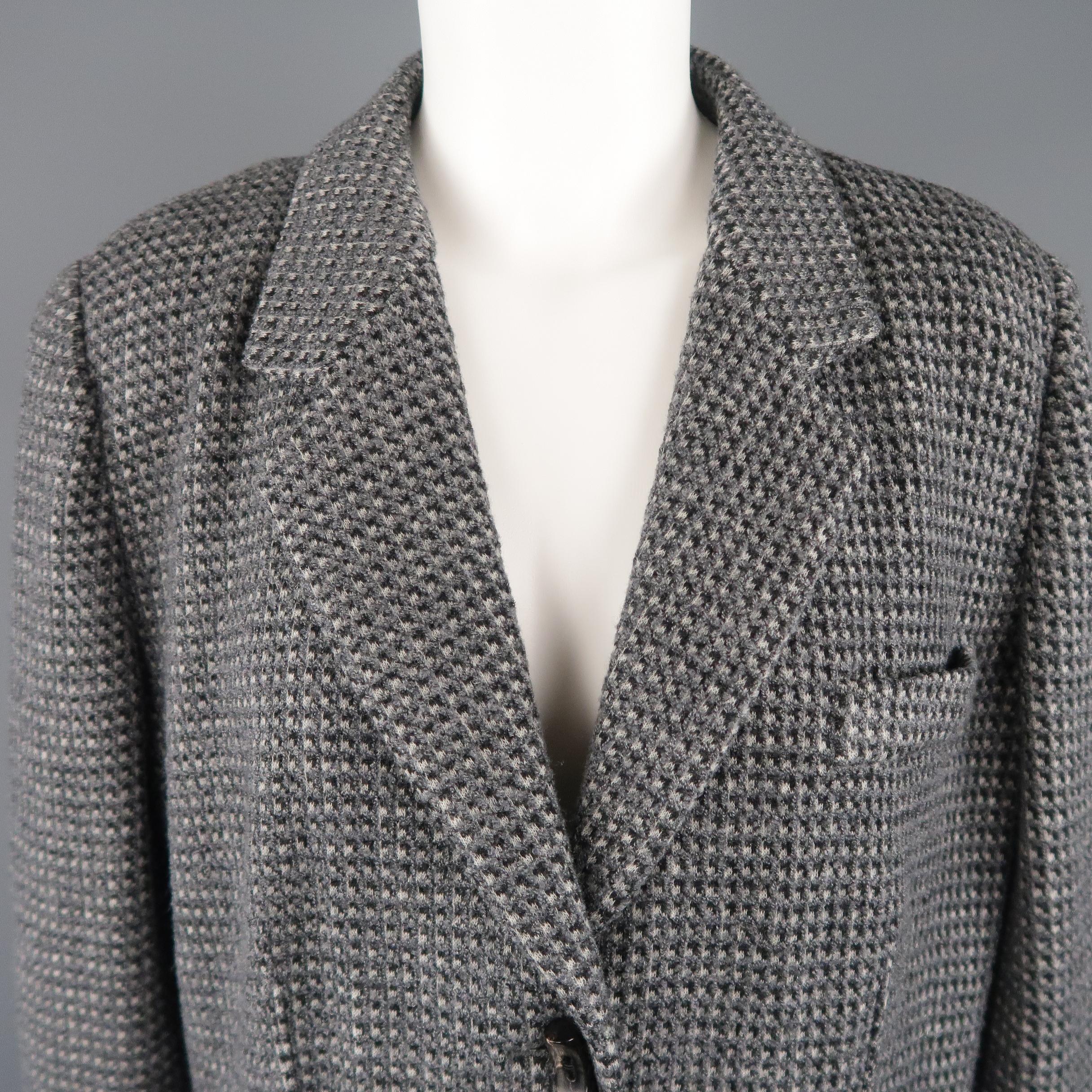 GIORGIO ARMANI sport jacket comes in a gray textured wool blend knit with a notch lapel, single breasted three button front, button cuffs, and ventless back. Made in Italy.
 
Excellent Pre-Owned Condition. Retails: $2,500.00.
Marked: IT 52
