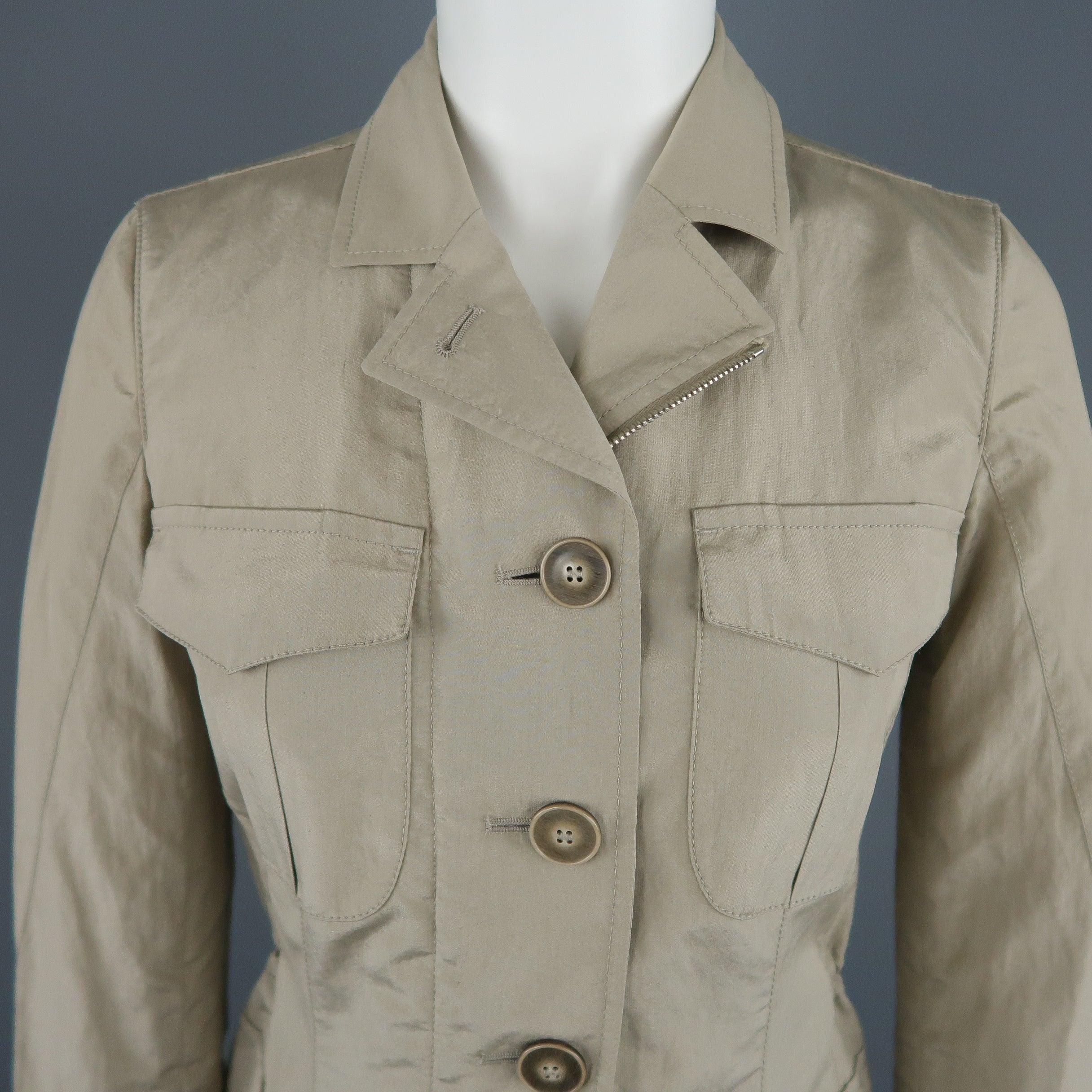 GIORGIO ARMANI Safari style jacket comes in khaki silk blend taffeta with a double zip and button closure, patch flap pockets, pointed collar, functional button cuffs, and elastic drawstring waist. Made in Italy.
Excellent Pre-Owned Condition.
