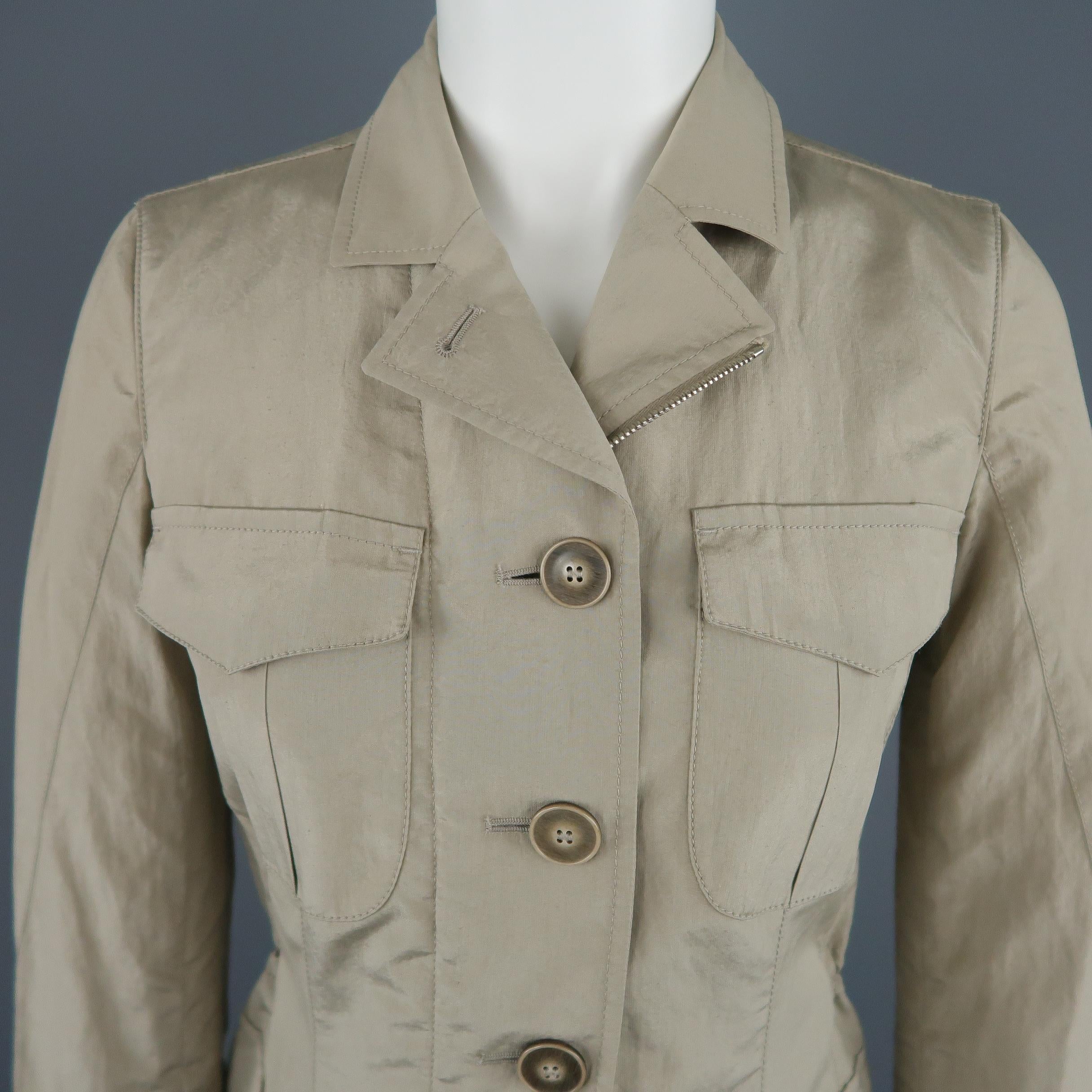 GIORGIO ARMANI Safari style jacket comes in khaki silk blend taffeta with a double zip and button closure, patch flap pockets, pointed collar, functional button cuffs, and elastic drawstring waist. Made in Italy.
 
Excellent Pre-Owned
