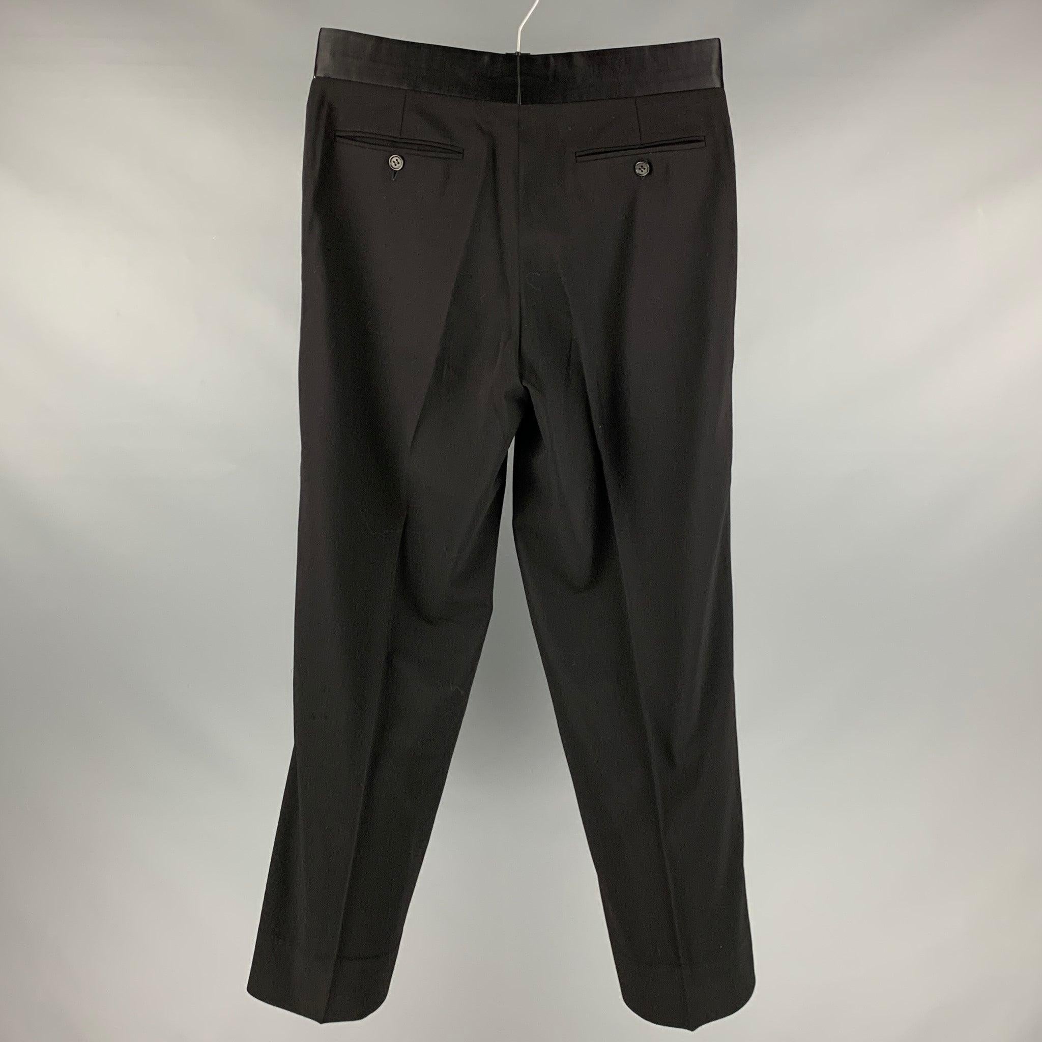 GIORGIO ARMANI tuxedo dress pants in a black wool fabric featuring a regular fit, tuxedo stripe, and zipper fly closure. Made in Italy.Excellent Pre-Owned Condition. 

Marked:  IT 50 

Measurements: 
 Waist: 32 inches Rise: 9.5 inches Inseam: 29
