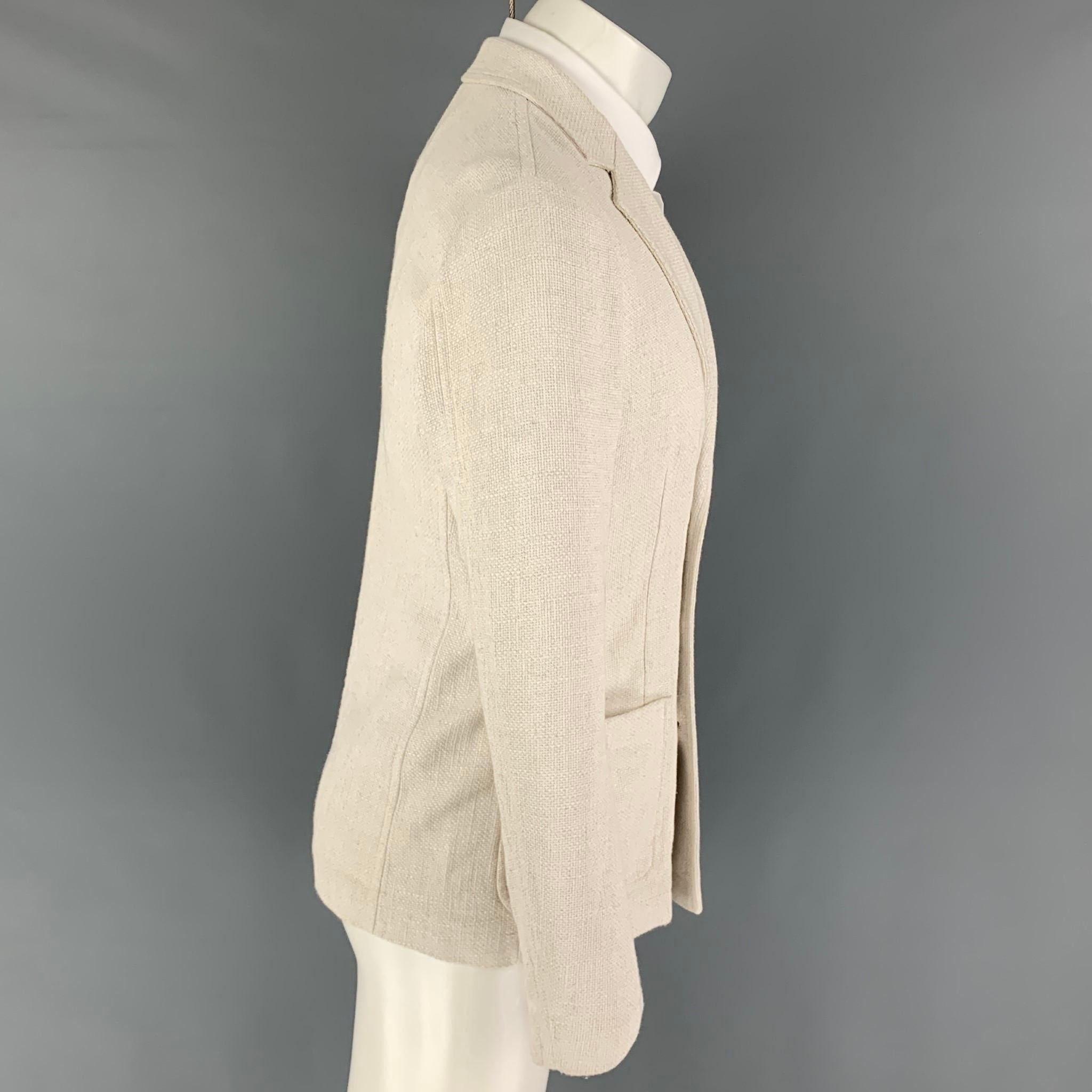 GIORGIO ARMANI sport coat comes in a off white woven viscose blend featuring a notch lapel, patch pockets, and a double breasted closure. Made in Italy. 

Excellent Pre-Owned Condition.
Marked: 46

Measurements:

Shoulder: 17 in.
Chest: 36