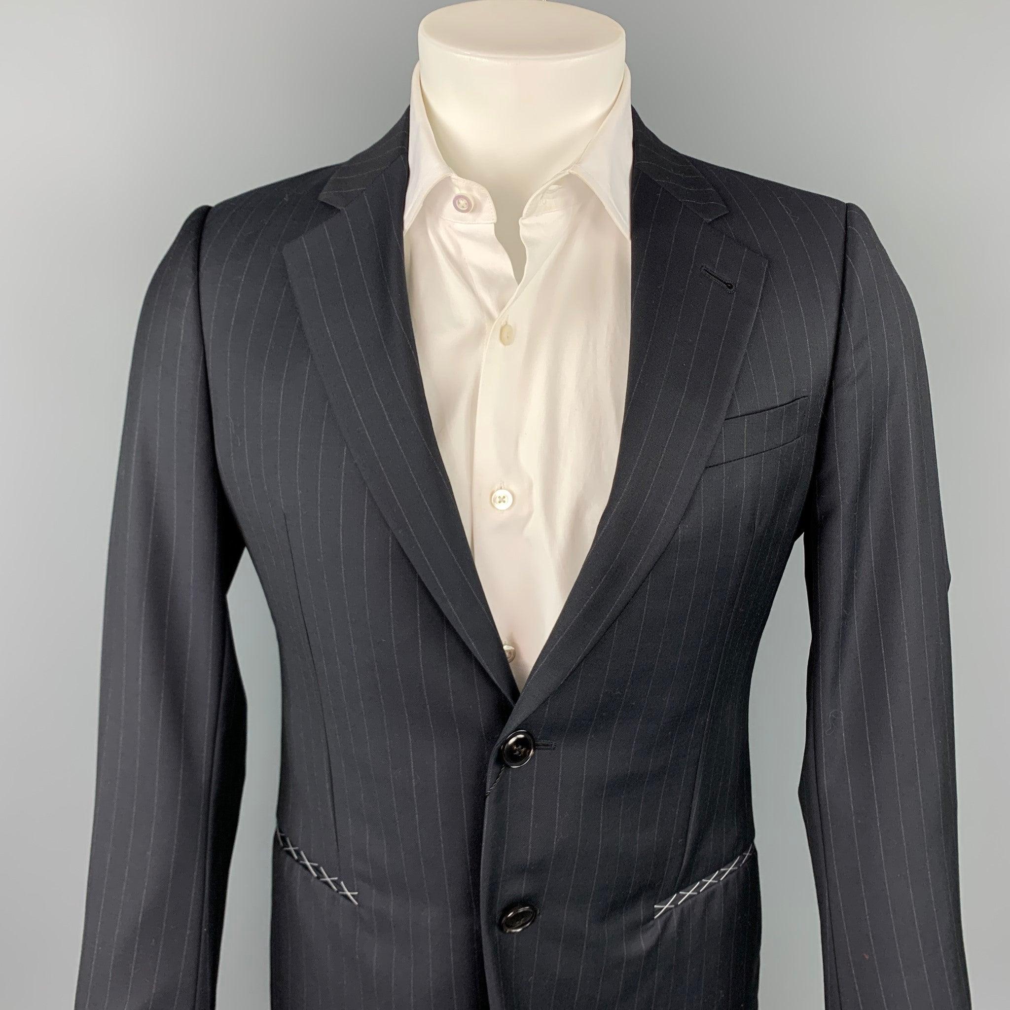 GIORGIO ARMANI sport coat comes in a navy chalk stripe wool with a full monogram print liner featuring a notch lapel, slit pockets, and a two button closure. Made in Italy.New With Tags.
 

Marked:   TG 46 

Measurements: 
 
Shoulder: 17 inches 
