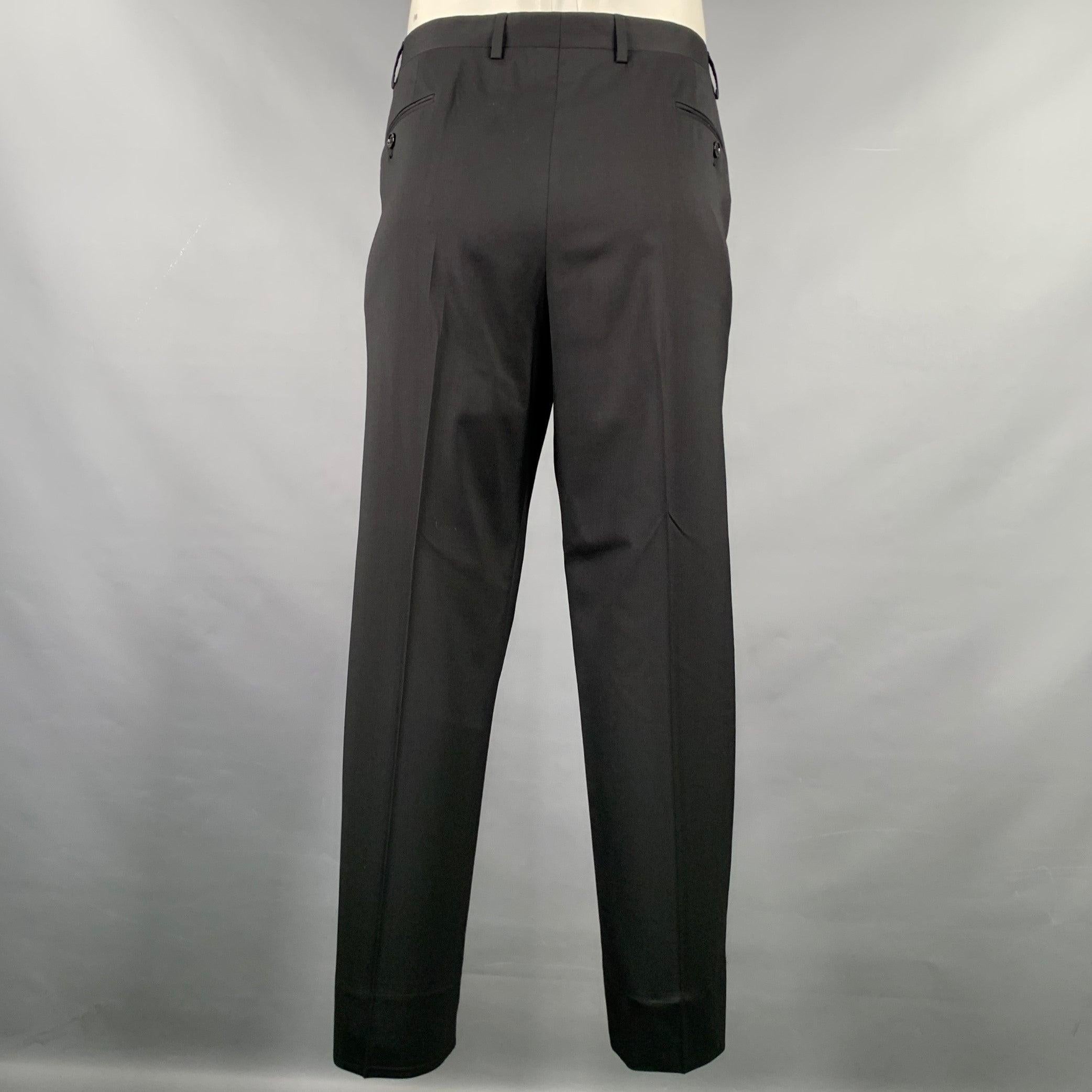 GIORGIO ARMANI dress pants
in a black wool stretch blend fabric featuring a flat front style, straight leg, and zip fly closure. Made in Italy.Excellent Pre-Owned Condition. 

Marked:   54 

Measurements: 
  Waist: 38 inches Rise: 9 inches Inseam: