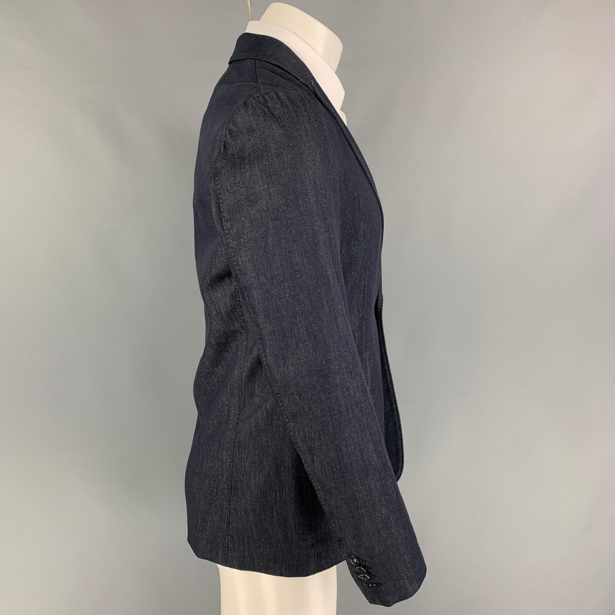 GIORGIO ARMANI sport coat comes in a indigo cotton with a half liner featuring a peak lapel, slit pockets, and a single button closure. Made in Italy. 

New With Tags. 
Marked: 52

Measurements:

Shoulder: 18 in.
Chest: 40 in.
Sleeve: 25 in.
Length: