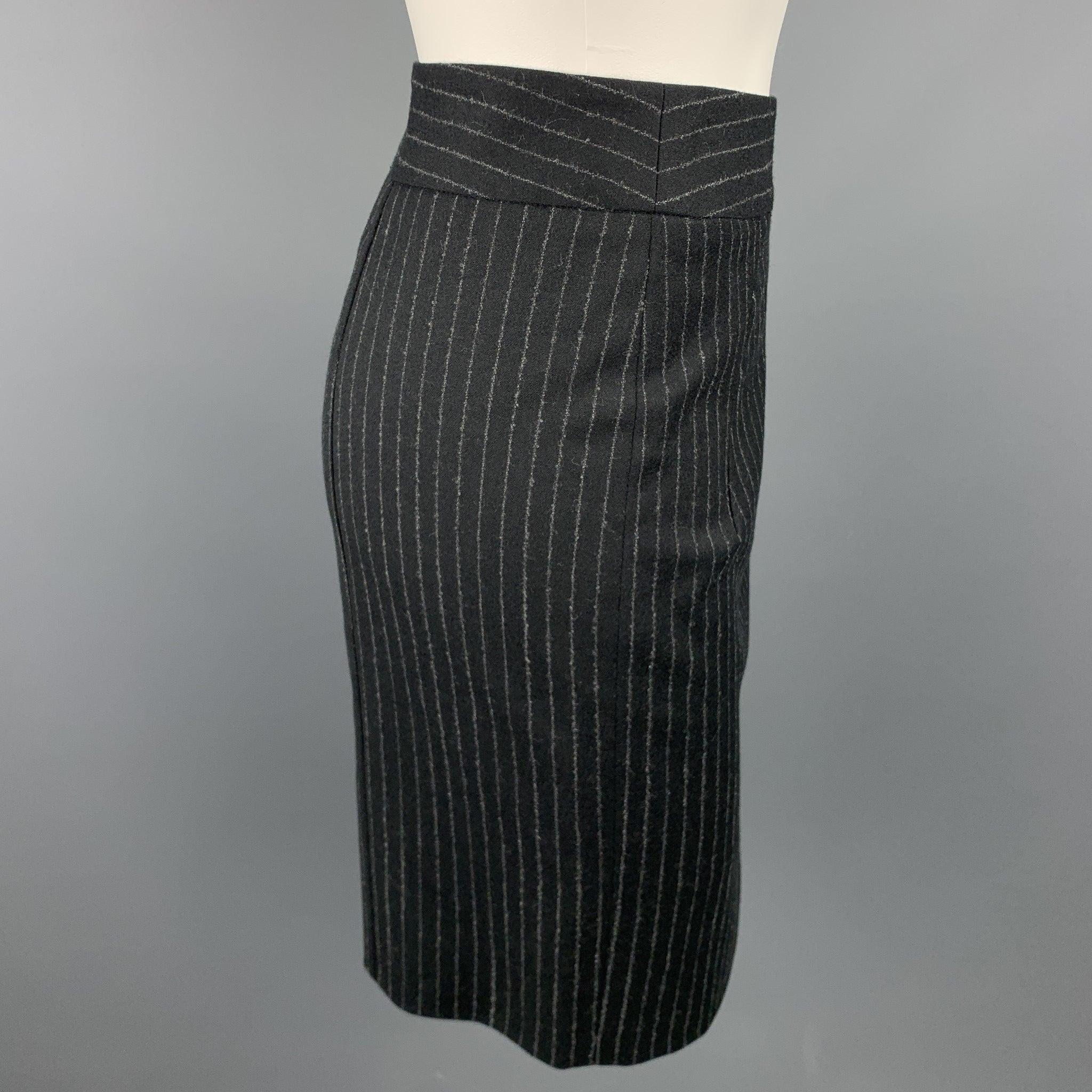 GIORGIO ARMANI skirt comes in a black & gray pinstripe with a full slip liner featuring a pencil style, back vent, and back zipper closure.
 Excellent
 Pre-Owned Condition. 
 

 Marked:  Size not visible
  
 

 Measurements: 
  Waist: 28 inches 
