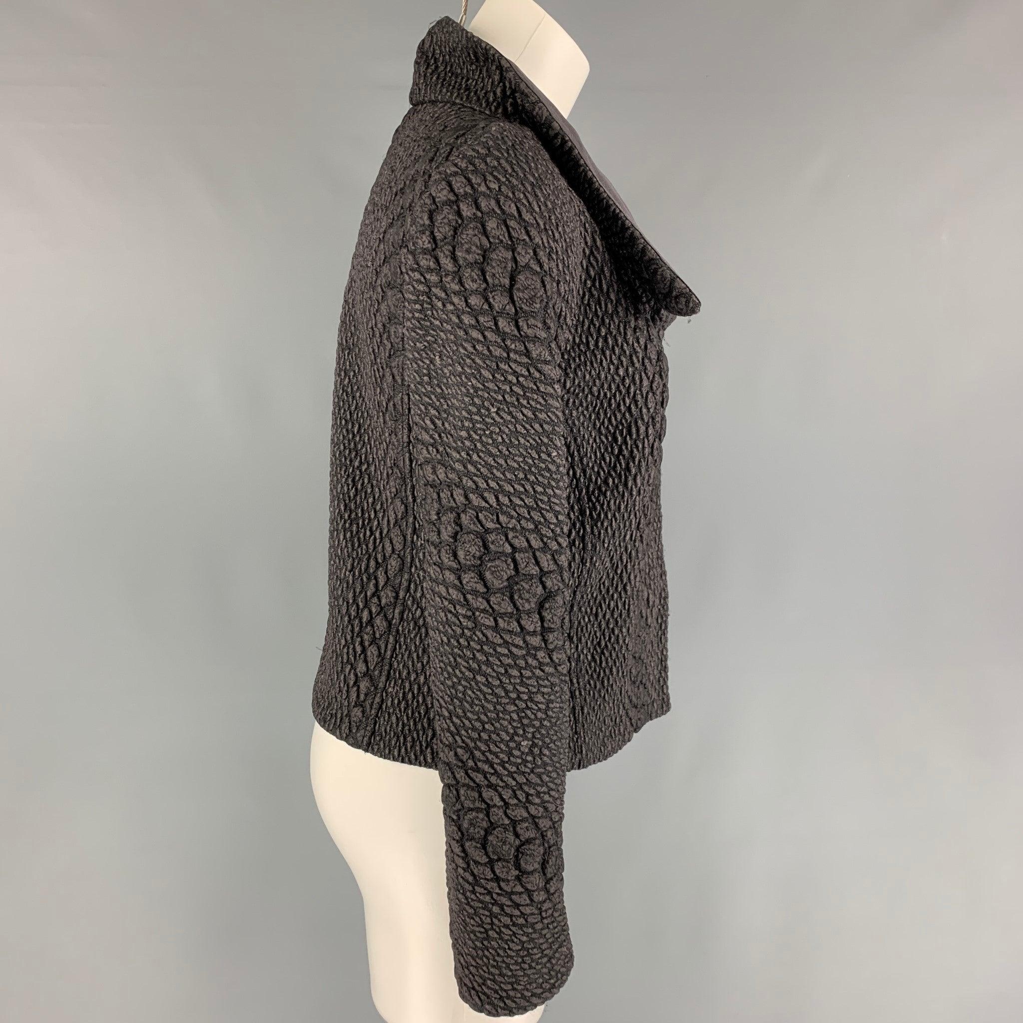 GIORGIO ARMANI jacket comes in a charcoal & grey textured wool blend featuring a high collar, and a asymmetrical zip up closure.
Very Good
Pre-Owned Condition. 

Marked:   40  

Measurements: 
 
Shoulder:
14.5 inches  Bust:
34 inches  Sleeve: 23.5