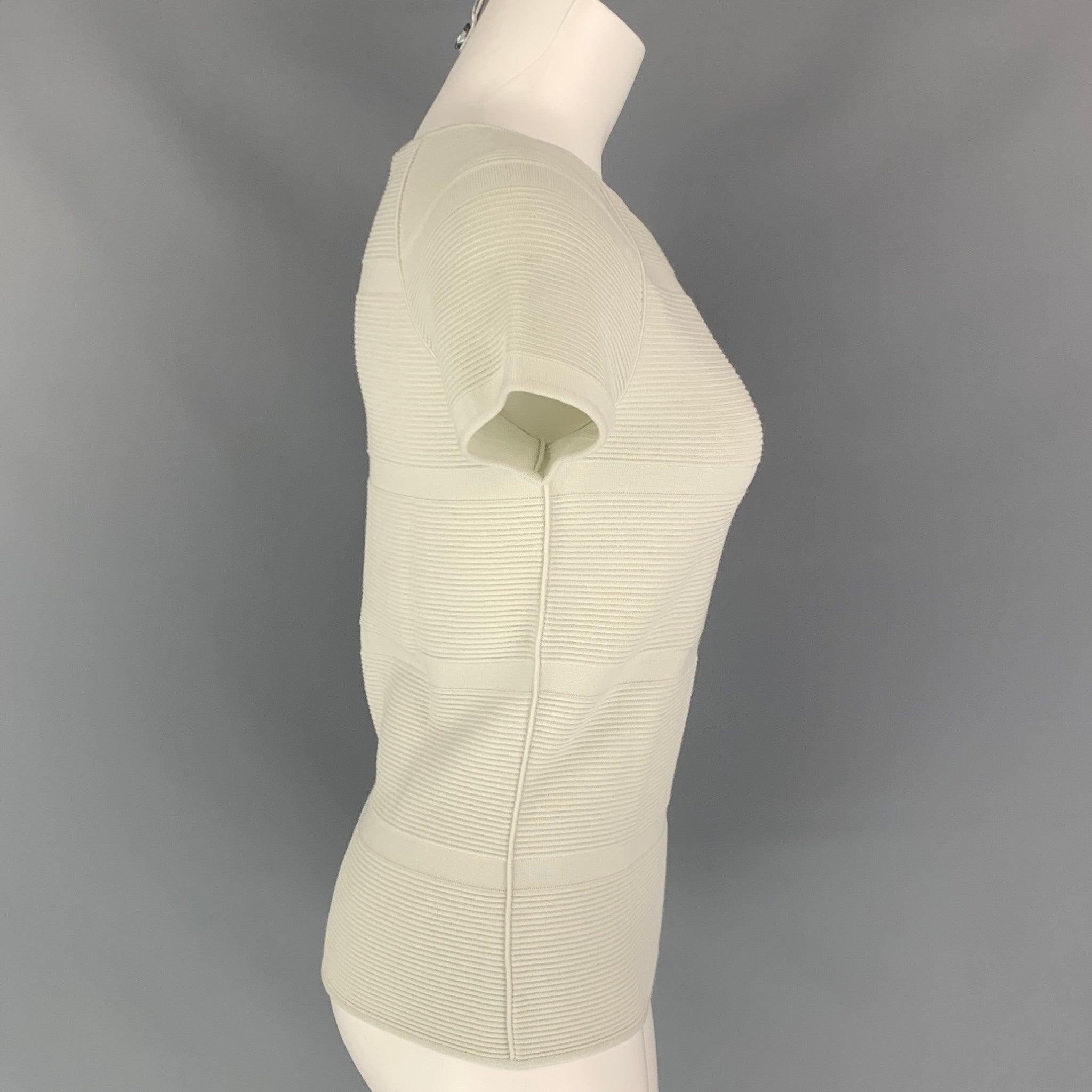 GIORGIO ARMANI casual top comes in a sea foam ribbed viscose / polyester featuring short sleeves and a boat neckline. Comes with tags. Made in Italy.Very Good
Pre-Owned Condition. Minor marks ar front.  

Marked:   40 

Measurements: 
 
Shoulder: 17