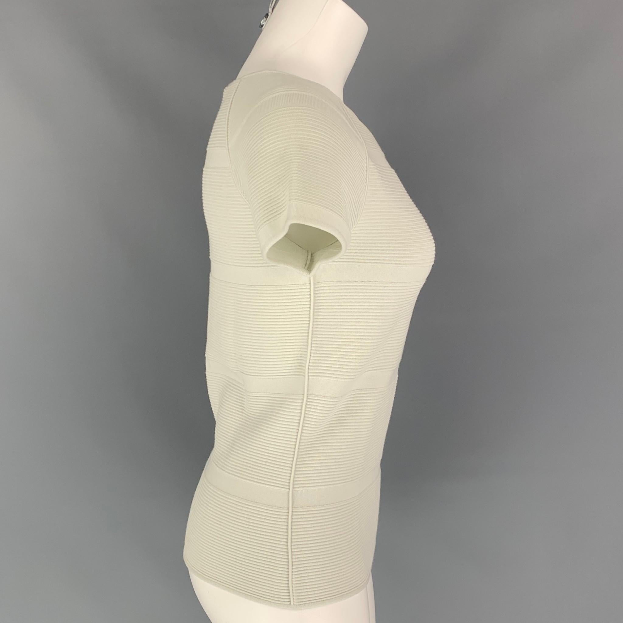 GIORGIO ARMANI casual top comes in a sea foam ribbed viscose / polyester featuring short sleeves and a boat neckline. Comes with tags. Made in Italy.

Very Good Pre-Owned Condition. Minor marks ar front.
Marked: 40
Original Retail Price: