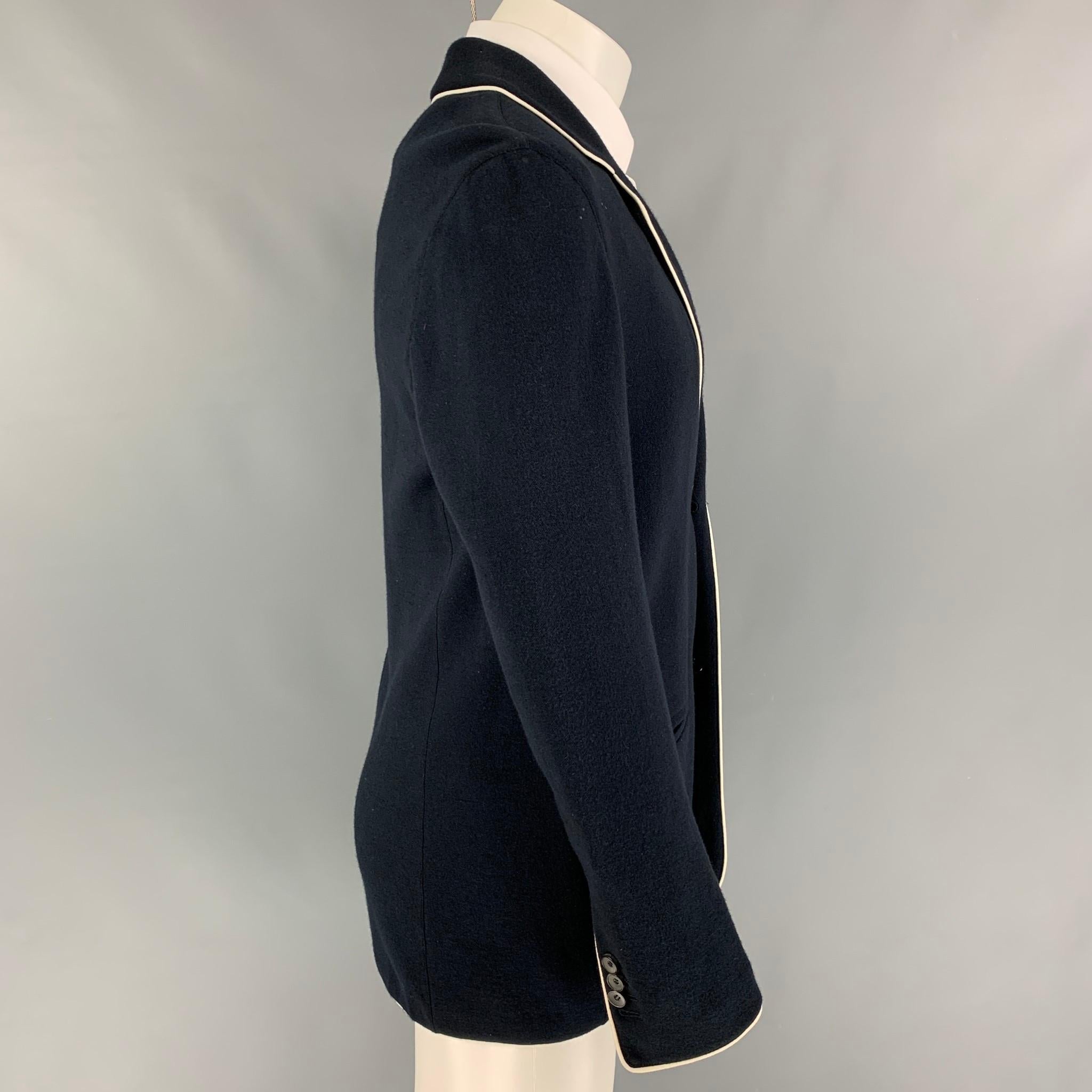 GIORGIO ARMANI sport coat comes in a navy cotton blend with white piping featuring a notch lapel, slit pockets, and a double button closure. Made in Italy. 

Very Good Pre-Owned Condition. Light marks at front.
Marked: 50

Measurements:

Shoulder: