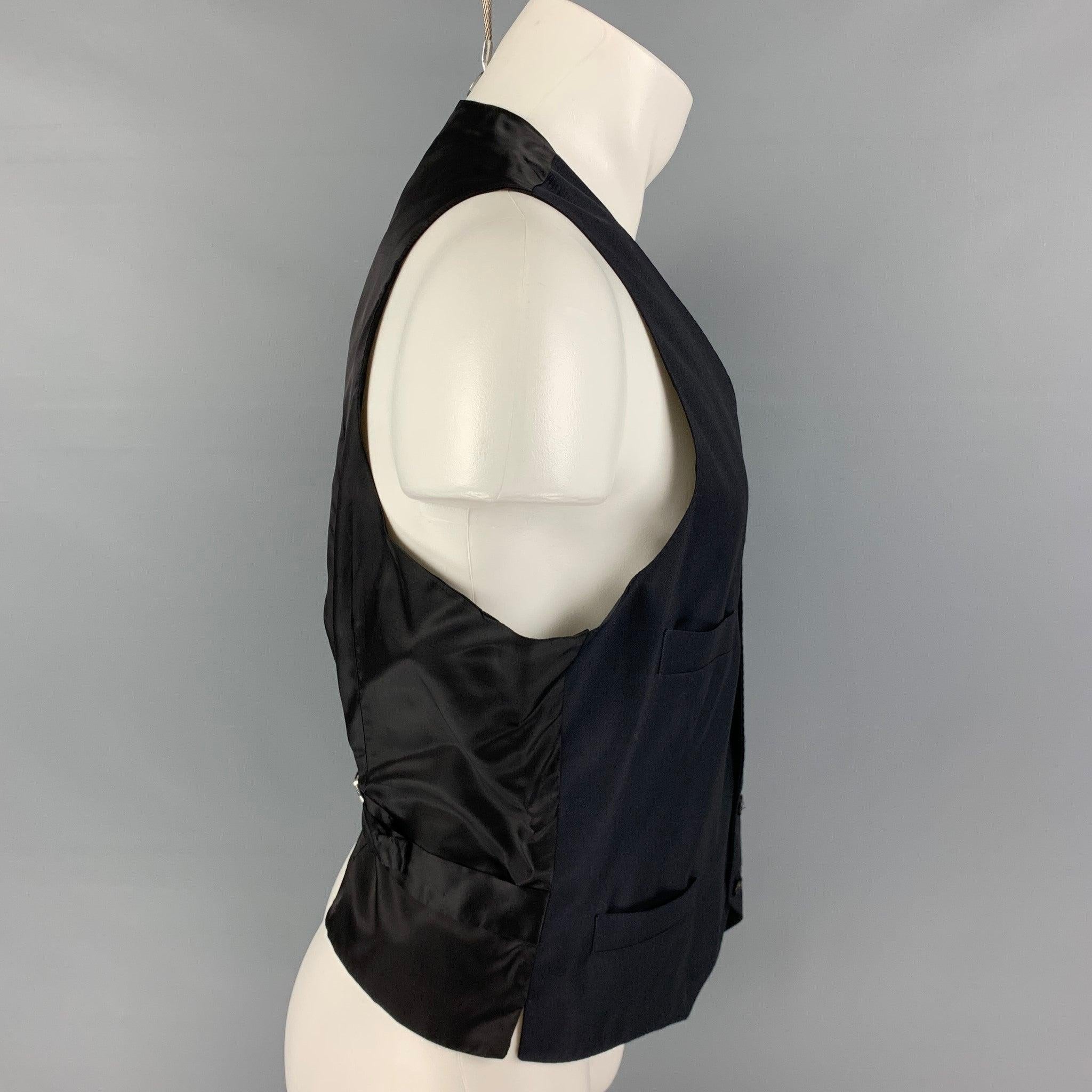 GIORGIO ARMANI vest comes in a navy wool / cashmere featuring a adjustable back, slit pockets, and a buttoned closure. Made in Italy.
Excellent
Pre-Owned Condition. 

Marked:   50  

Measurements: 
 
Shoulder: 14 inches Chest: 40 inches Length: 22