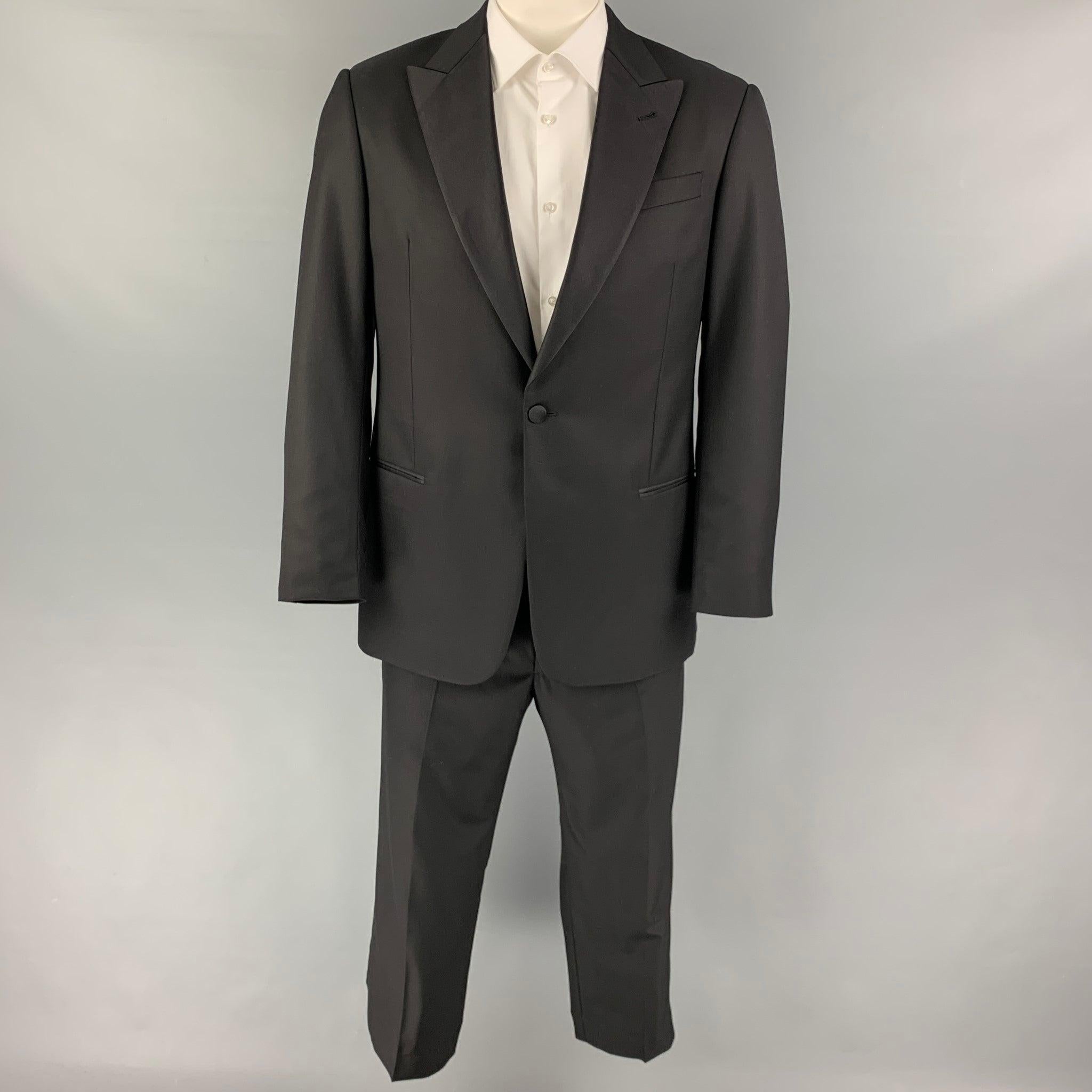 GIORGIO ARMANI
suit comes in a black wool with a full liner and includes a single breasted, single button sport coat with a peak lapel and matching flat front trousers. Excellent Pre-Owned Condition. 

Marked:   52  

Measurements: 
 