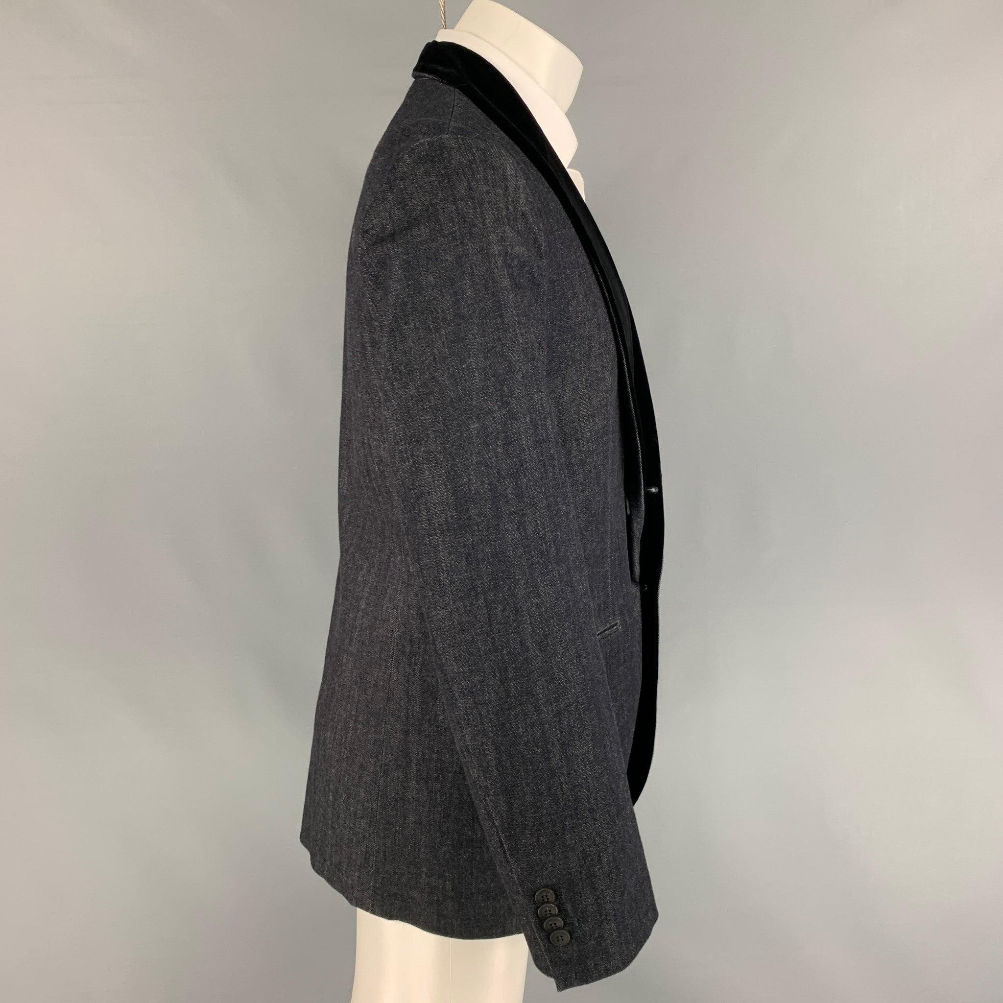 GIORGIO ARMANI sport coat comes in a indigo cotton / cashmere featuring a velvet shawl collar, slit pockets, and a double button closure. Made in Italy.
Very Good
Pre-Owned Condition.  

Marked:   54 

Measurements: 
 
Shoulder: 18 inches  Chest: 44
