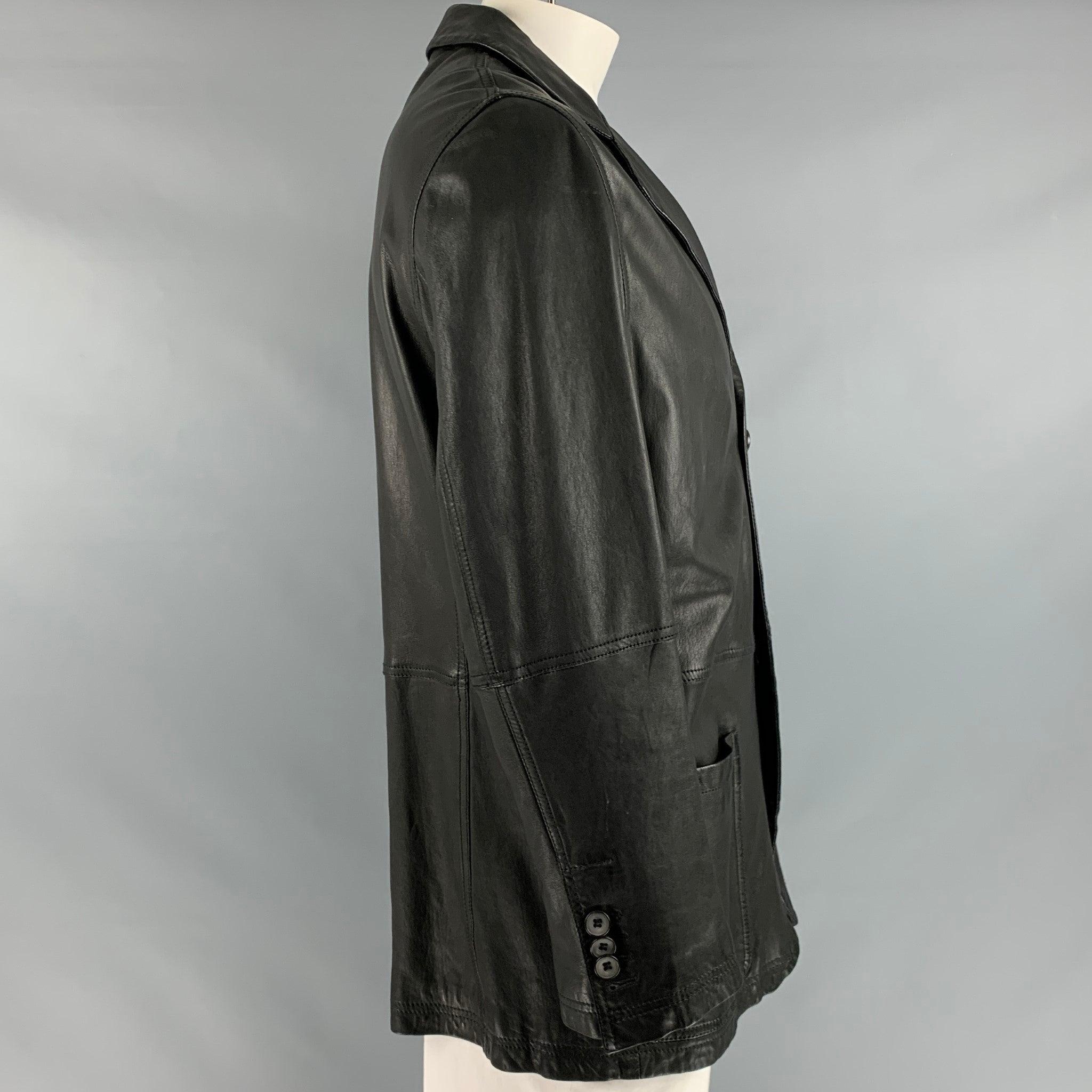 GIORGIO ARMANI jacket in a black leather fabric featuring a single breasted style, working cuff buttons, and a two button closure.Very Good Pre-Owned Condition. Minor signs of wear. 

Marked:   56 

Measurements: 
 
Shoulder: 19 inches Chest: 41