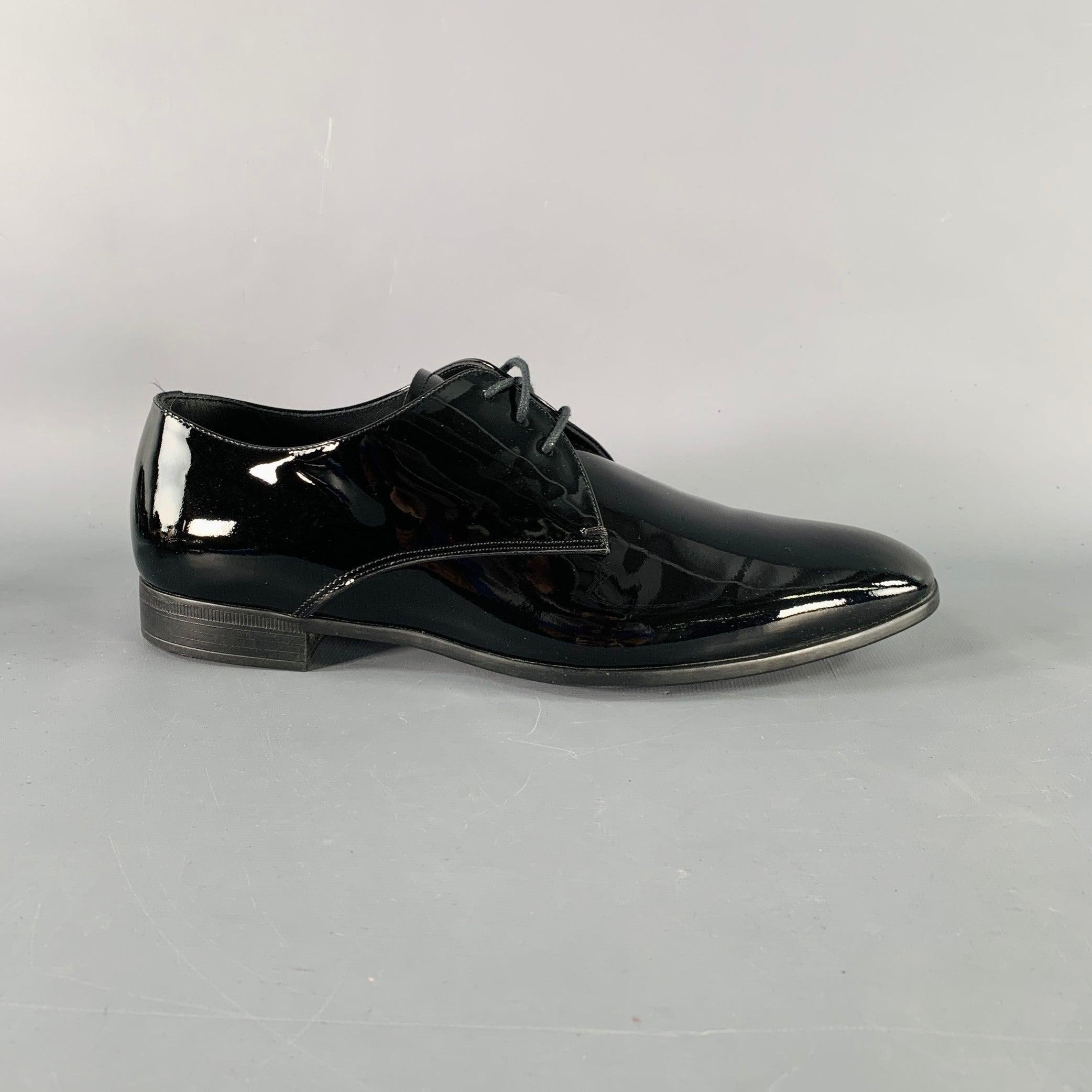 GIORGIO ARMANI shoes
in a black patent leather featuring a derby style, almond toe, and lace-up closure. Comes with box. Made in Italy.New with Box. 

Marked:  
X2C036 5Outsole: 10.5 inches  x 3.5 inches 
  
  
 
Sui Generis Reference: