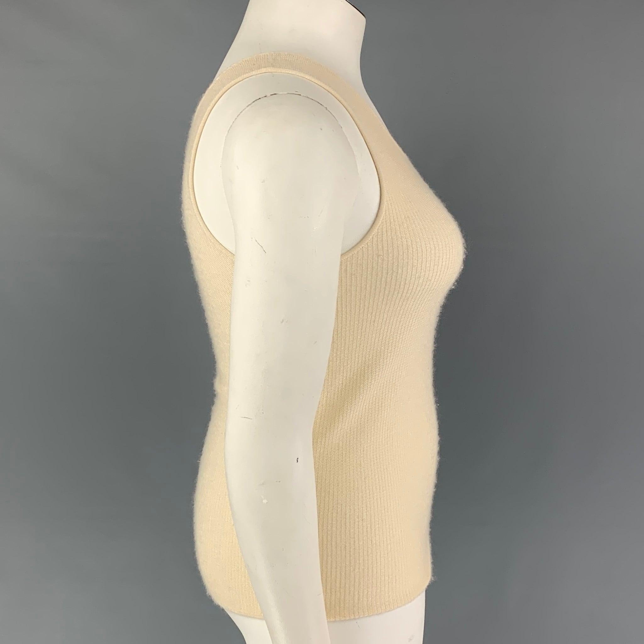 GIORGIO ARMANI tank top comes in a cream knitted rayon / cashmere. Made in Italy.Very Good
 Pre-Owned Condition. 
 

 Marked:  44 
 

 Measurements: 
  Bust: 28 inches Length: 21 inches 
  
  
  
 Sui Generis Reference: 122015
 Category: Casual Top
