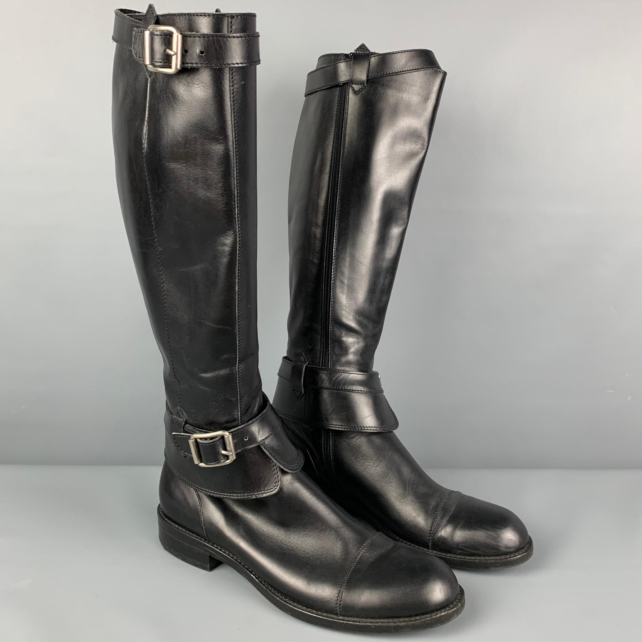 GIORGIO ARMANI boots comes in a black leather featuring a riding style, belt strap details, and a cap toe. Made in Italy. 

Very Good Pre-Owned Condition.
Marked: 39 XGB213

Measurements:

Length: 11 in.
Width: 4 in.
Height: 15.5 in. 