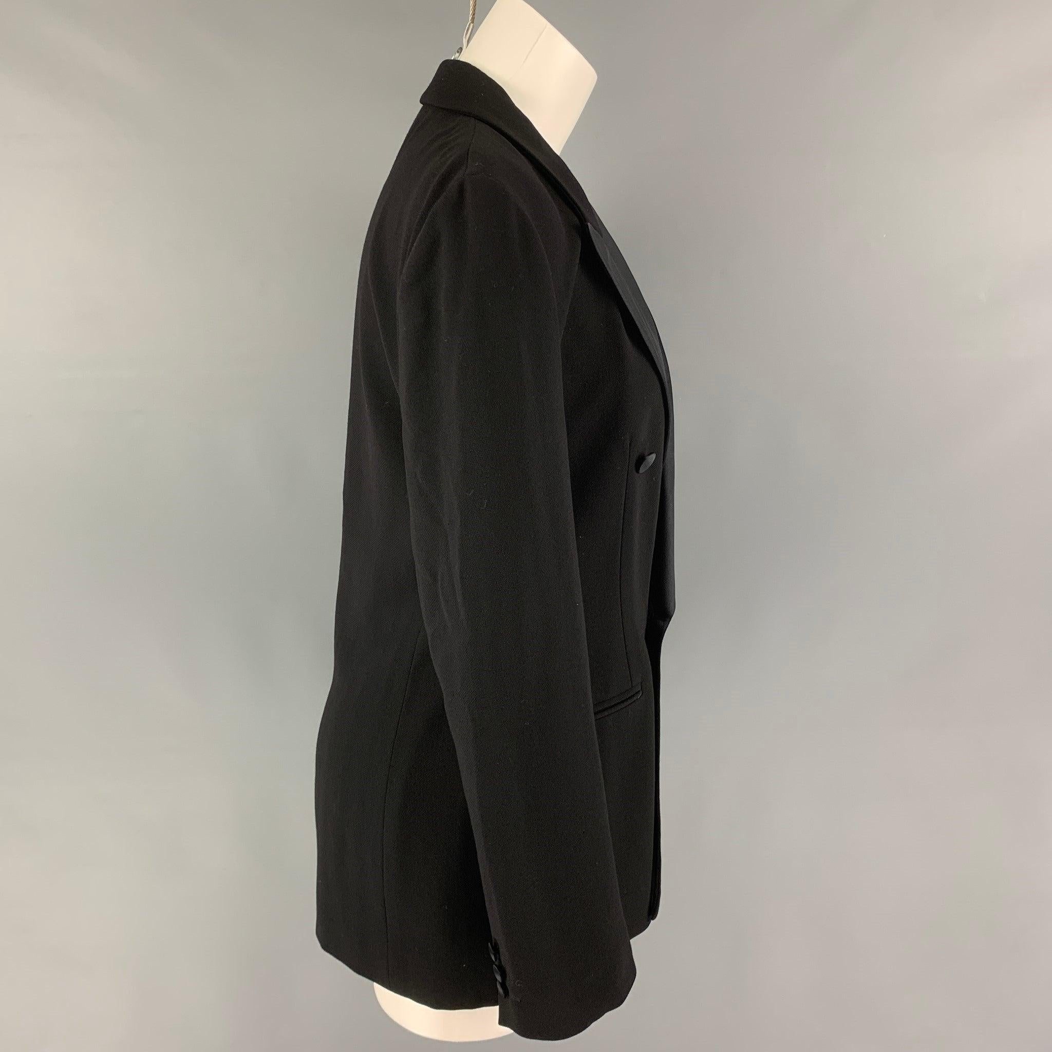 GIORGIO ARMANI jacket comes in a black wool with a full liner featuring a peak lapel, slit pockets, and a double breasted closure. Made in Italy.
Excellent Pre-Owned Condition. 

Marked:   42 

Measurements: 
 
Shoulder: 17.5 inches Bust: 36 inches