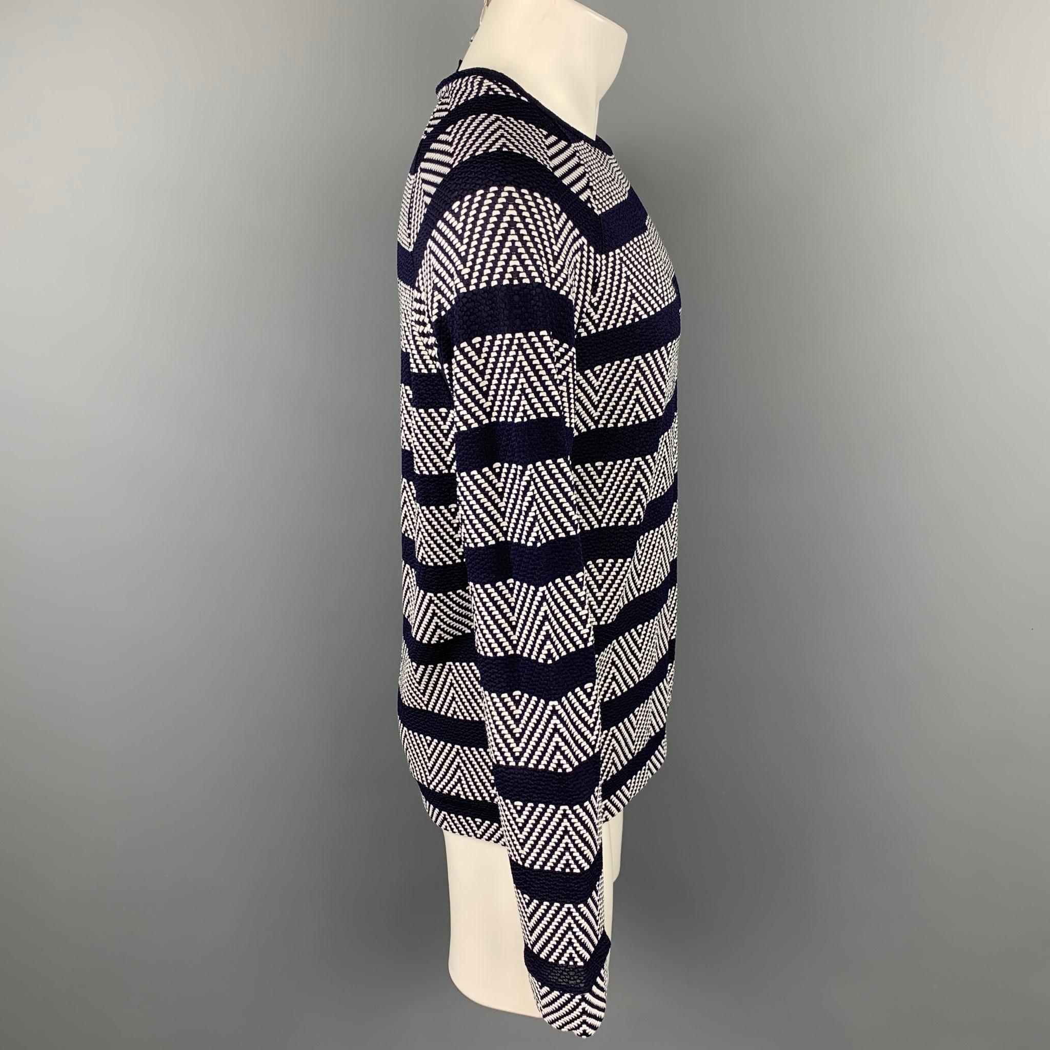 GIORGIO ARMANI pullover comes in a navy & white textured viscose blend featuring a raglan style and a crew-neck. Made in Italy

Excellent Pre-Owned Condition.
Marked: IT 50

Measurements:

Shoulder: 16.5 in.
Chest: 42 in.
Sleeve: 30 in.
Length: 28