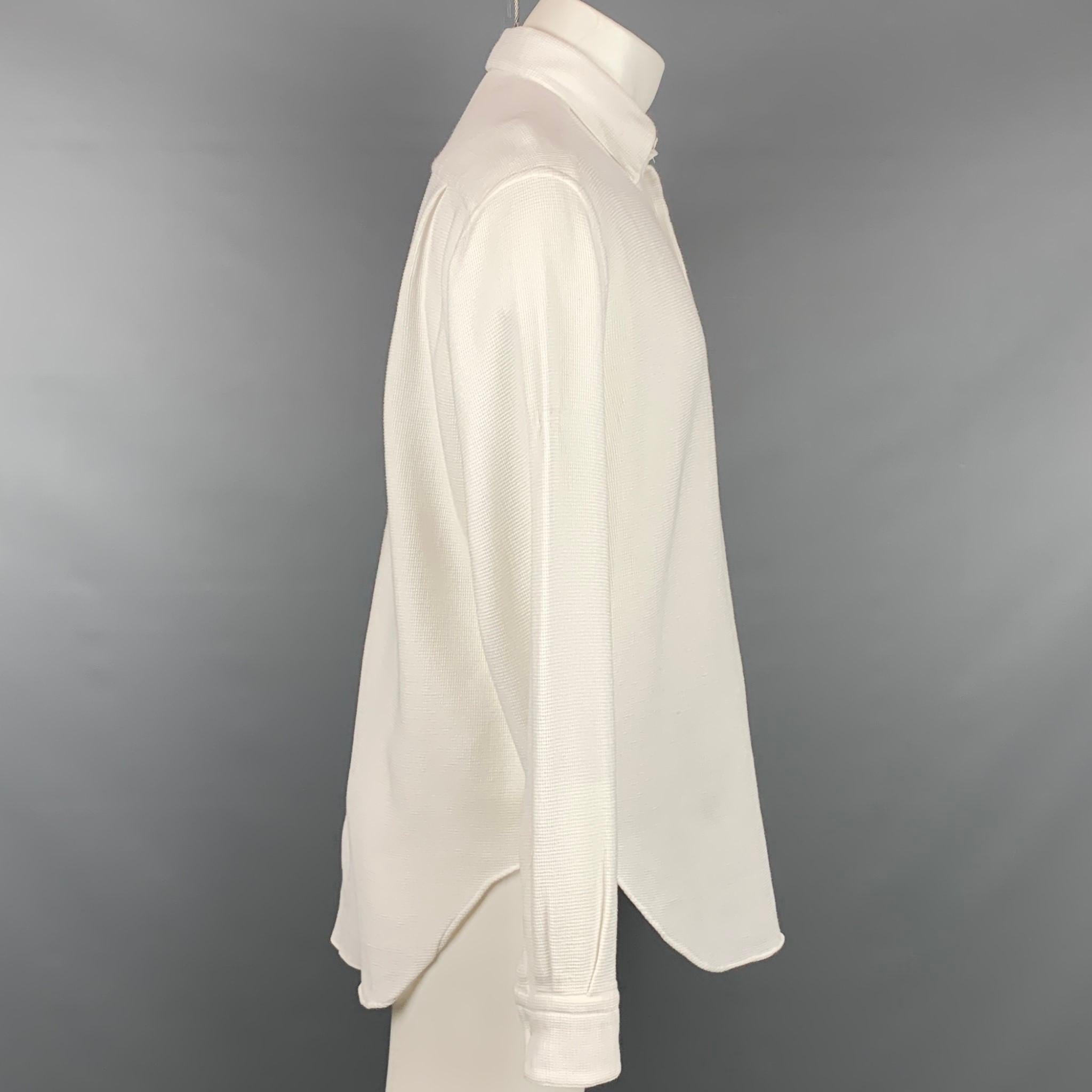 GIORGIO ARMANI long sleeve shirt comes in a white waffle knit cotton featuring a button down style and a front pocket. Made in Italy.

Very Good Pre-Owned Condition.
Marked: 15.5/39

Measurements:

Shoulder: 19 in.
Chest: 44 in.
Sleeve: 27