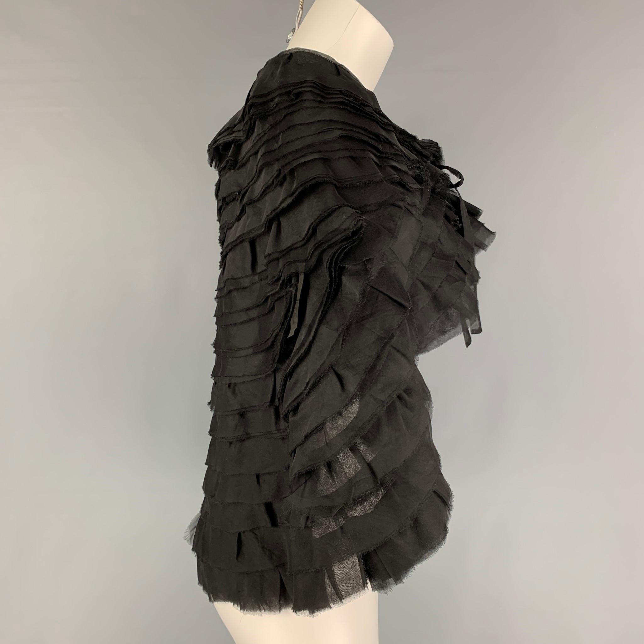 GIORGIO ARMANI cape comes in a black textured silk featuring a ruffled design and a self-tie closure. Made in Italy.

Very Good Pre-Owned Condition.
Marked: One Size

Measurements:

Shoulder: 18 in.
Length: 21.5 in. 