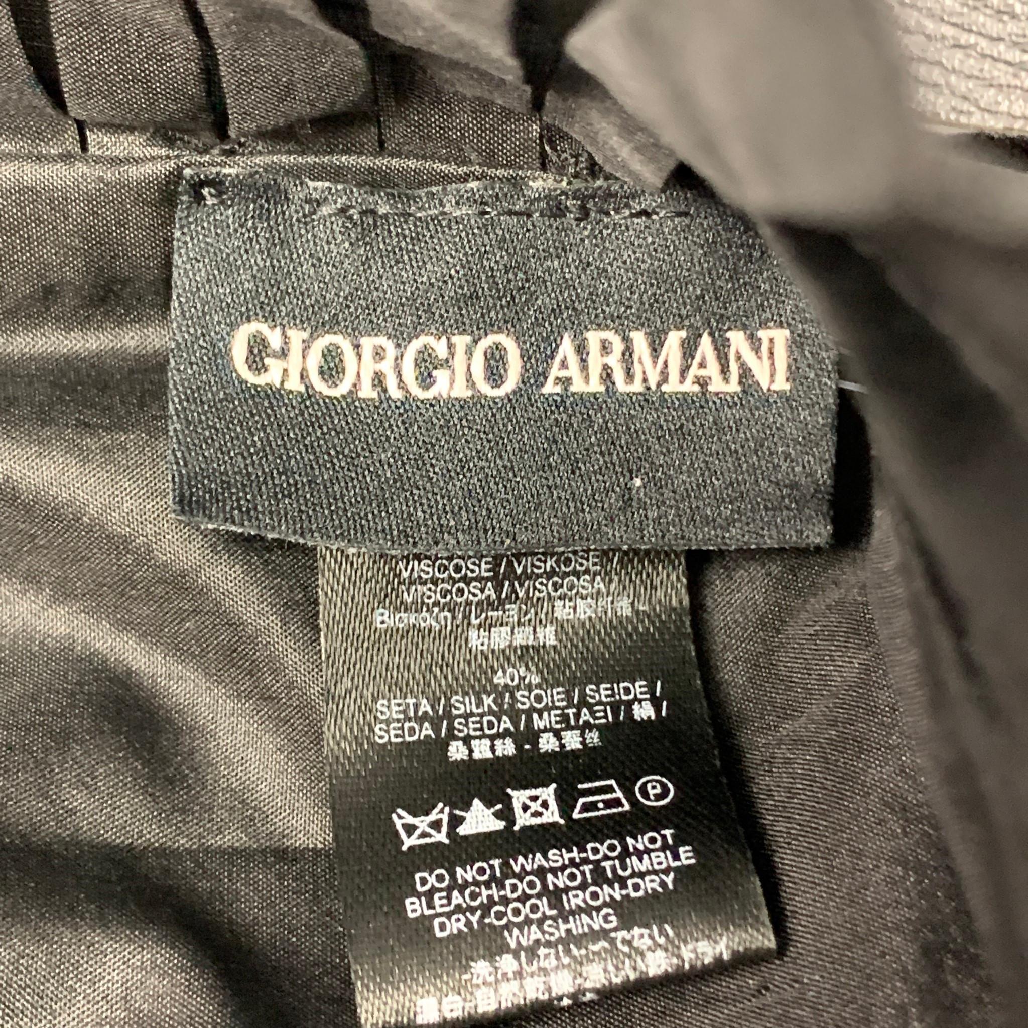 GIORGIO ARMANI jacket comes in a black viscose velvet featuring a cape style, ruffle hem, and a open front. Made in Italy. 

Very Good Pre-Owned Condition.
Marked: One size

Measurements:

Sleeve: 15 in.
Length: 17.5 in. 