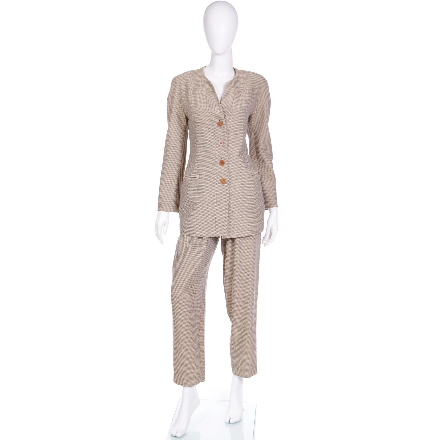 This is a fabulous vintage Giorgio Armani Le Collezioni suit that is in a beige and grey Toned check wool blend fabric. This outfit is a great example of the timeless appeal of Giorgio Armani and we love the way it can seamlessly blend into a modern