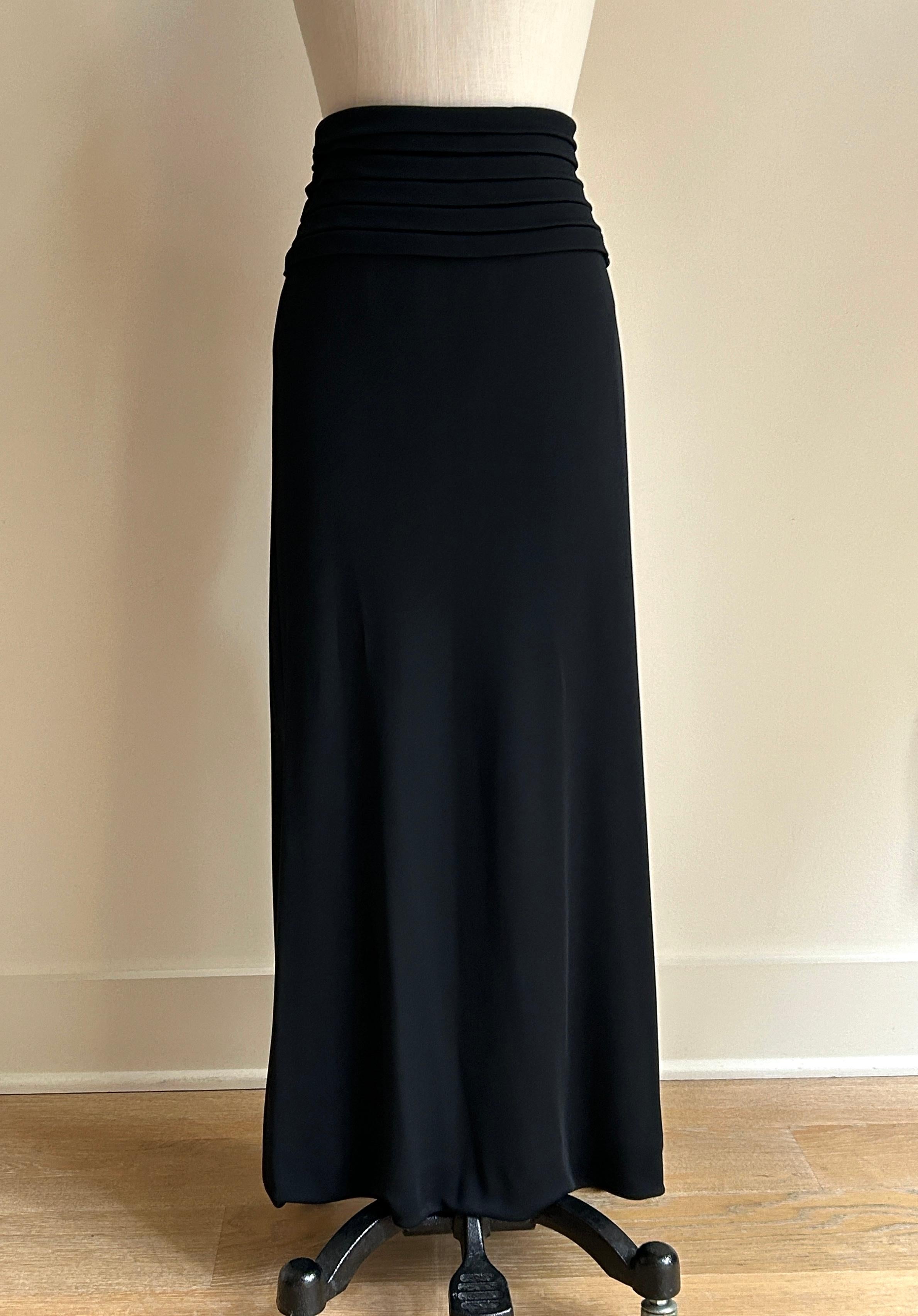Unworn vintage 1990s Giorgio Armani black lightweight jersey knit straight skirt that hits just between a midi and maxi length. Stacked horizontal pleats at waist. Side zip and interior button. 

82% viscose, 18% polyamide. 
Fully lined in 82%