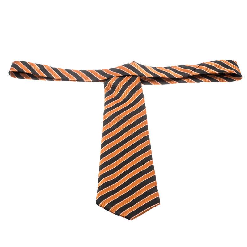Cut from quality silk, this Giorgio Armani tie features diagonal stripes of orange and black in jacquard all over. The piece is complete with the brand label and the keeper loop on the back. Look smart by pairing it with plain shirts.

