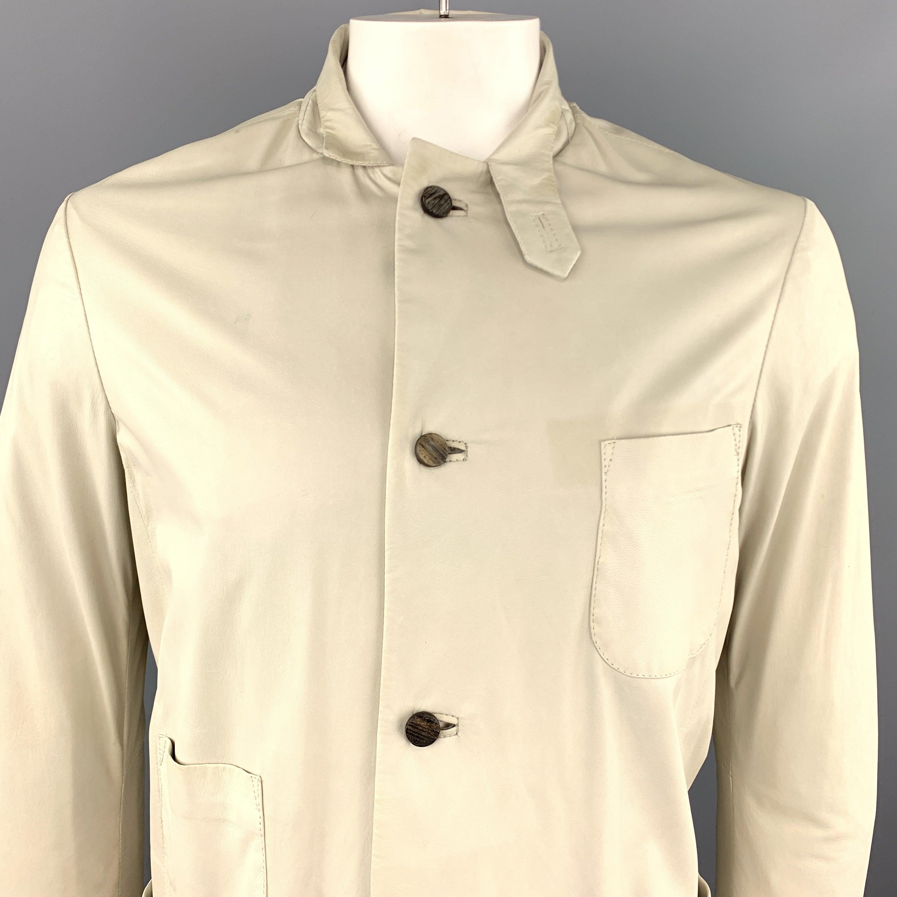 GIORGIO BRATO jacket comes in ultra soft, light weight ivory leather with a single breasted button up front, tab stand up collar, nylon liner, and patch pockets. Discolorations throughout leather. See detail shots. As-is. Made in Italy.Good