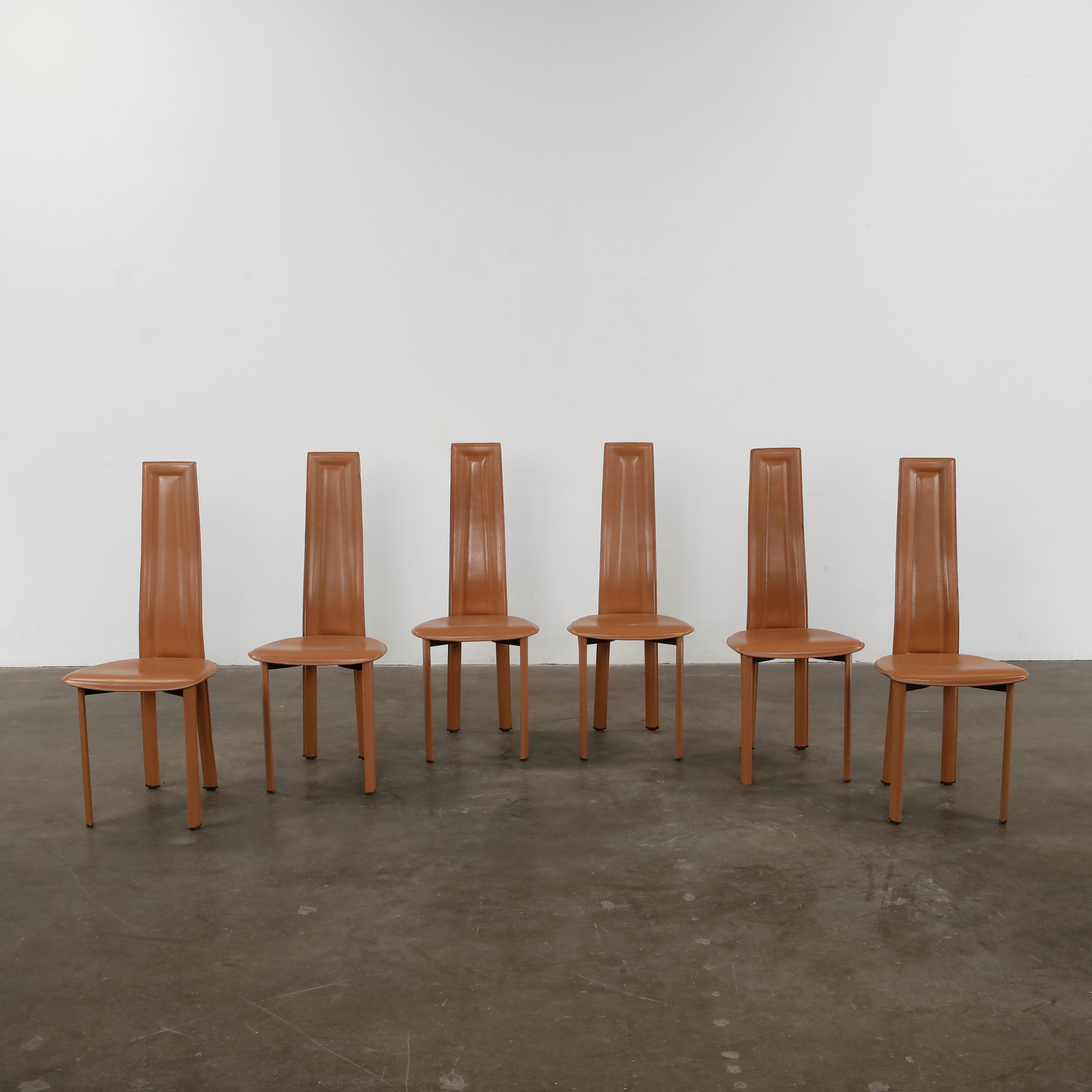 Sleek and modern set of six high-back dining chairs by Giorgio Cattelan for Cattelan, fully upholstered in cognac leather. Elegant and comfortable. Chairs: Height: 43 in. Width: 17.5 in. Depth: 17.5 in. Seat Depth: 16.1 in. Seat Height: 19.2 in.