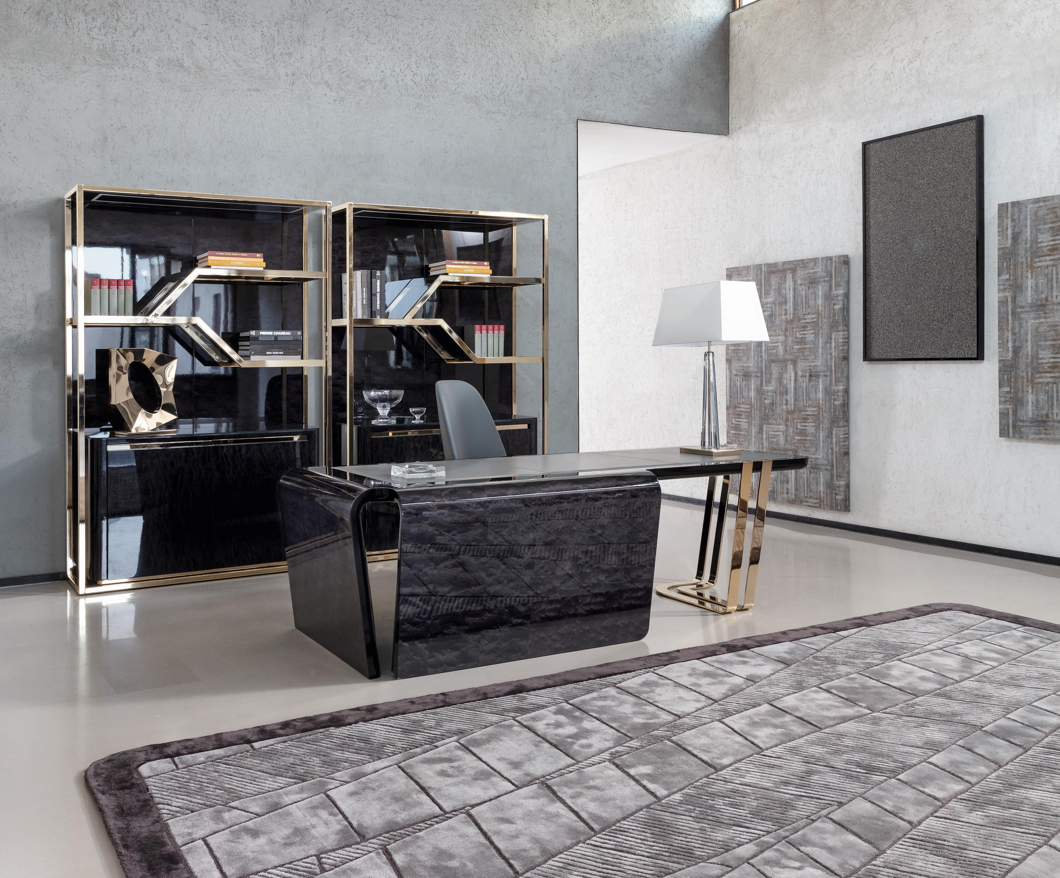 Italian desk crafted from Black Bubinga burl veneer features a stunning high gloss polyester finish, exuding elegance and sophistication. The top insert in grey leather adds a touch of luxury, making it both functional and stylish.

The legs and