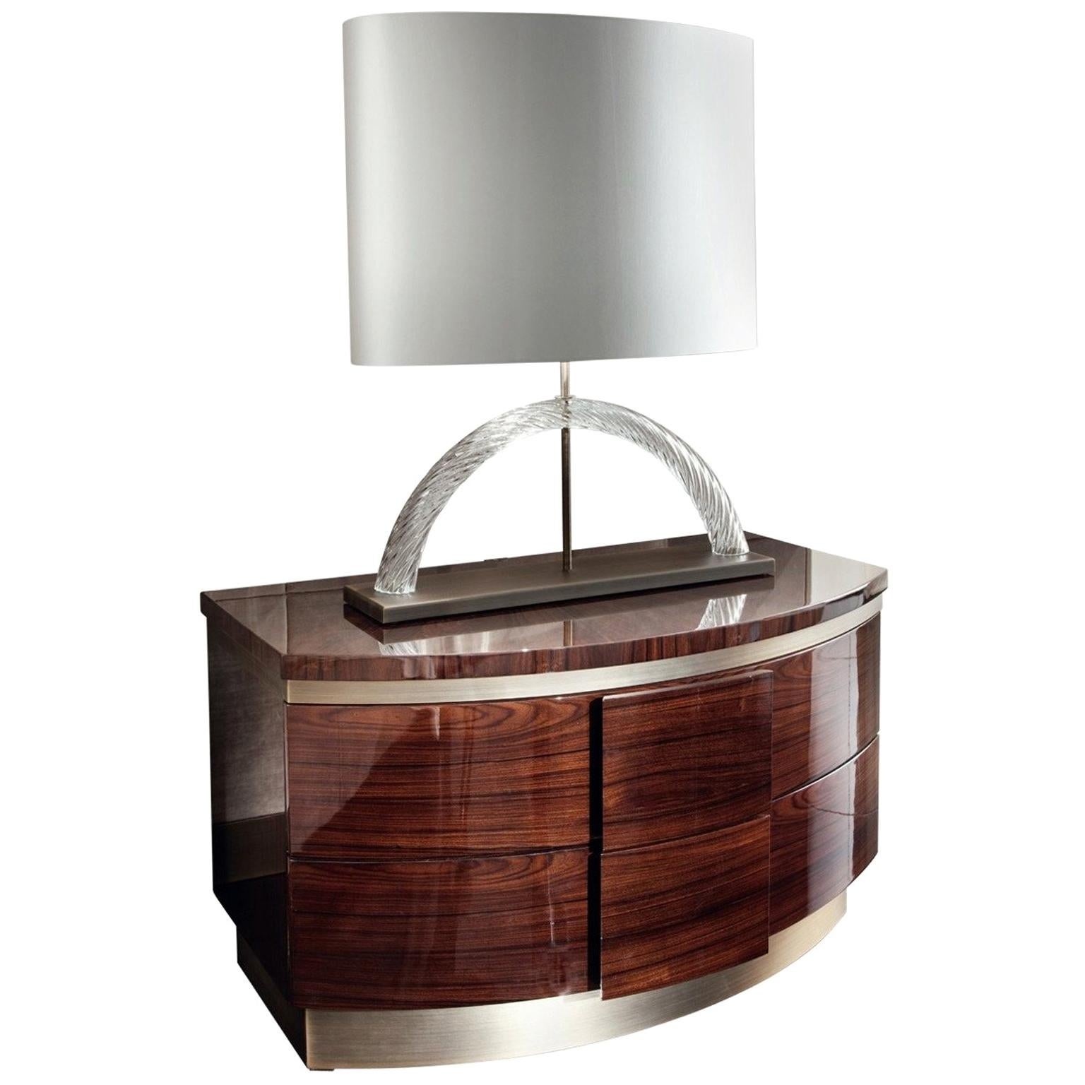 Nightstand sunburst top of Brazilian rosewood veneer, this night table is a striking piece. It is finished in a high gloss
veneer and set over a bronzed stainless steel base. This piece features two drawers for ample storage; both are lined in