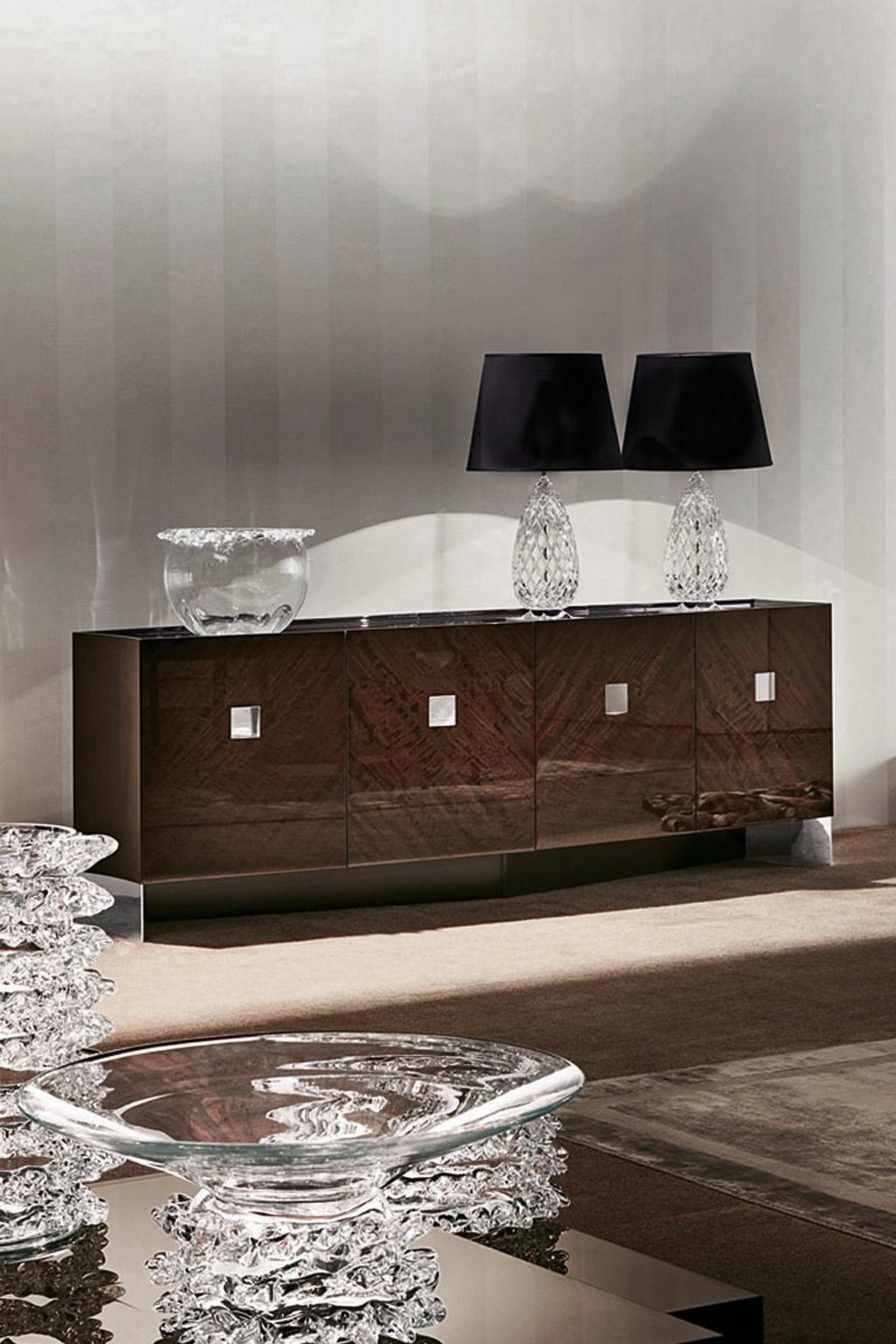 Buffet in European curly eucalyptus veneer in high gloss polyester.
Four doors with stainless steel insert.
Two inside full extension drawers; one big and two small inside adjustable
shelves.
LED light system with sensors in the two centre