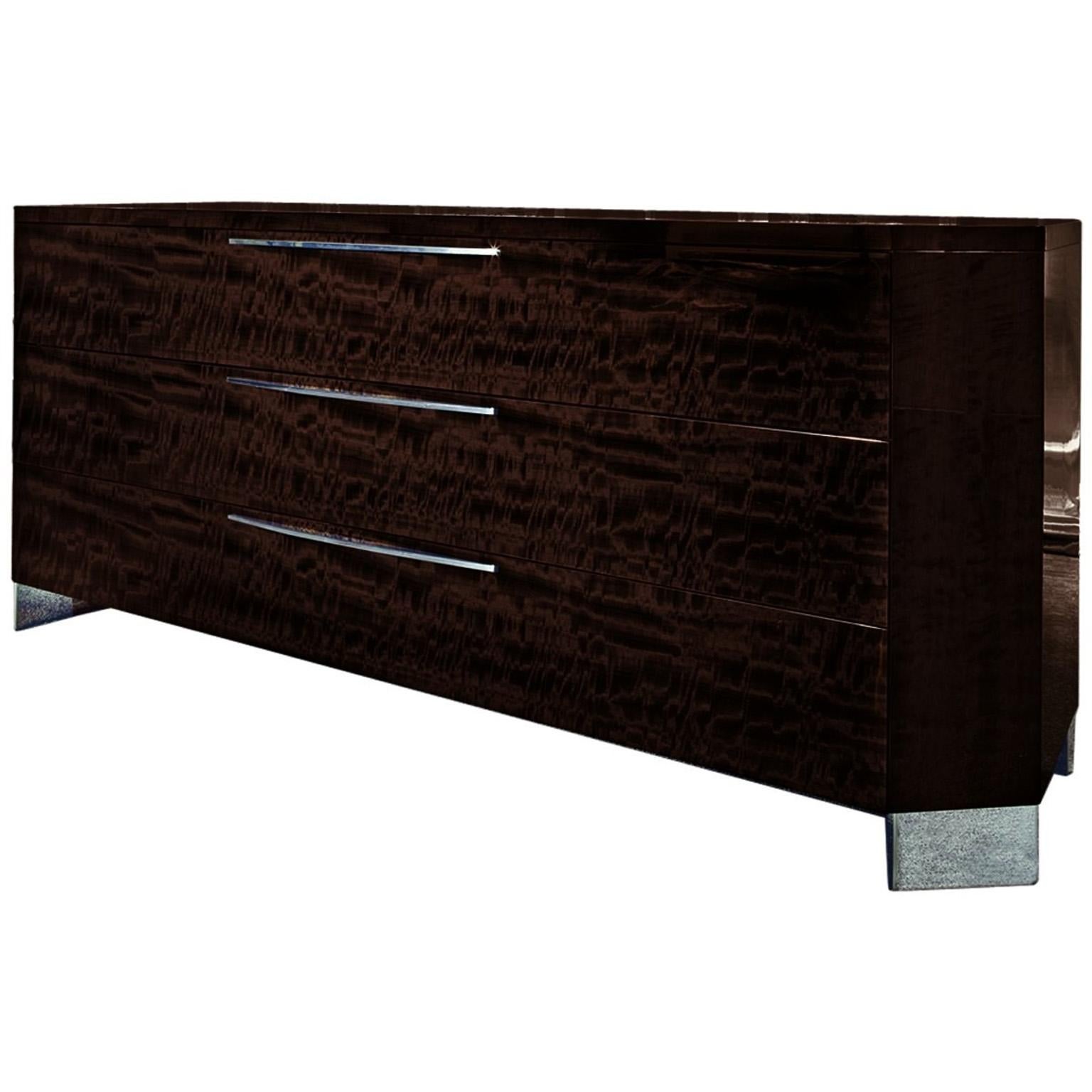 Giorgio Collection Dresser. Three-drawer dresser of European curly eucalyptus veneer in a high-gloss finish, inlay top, and chromed stainless steel hardware and feet. Three drawers are full-extension double drawers.
Accessories pictured on top of
