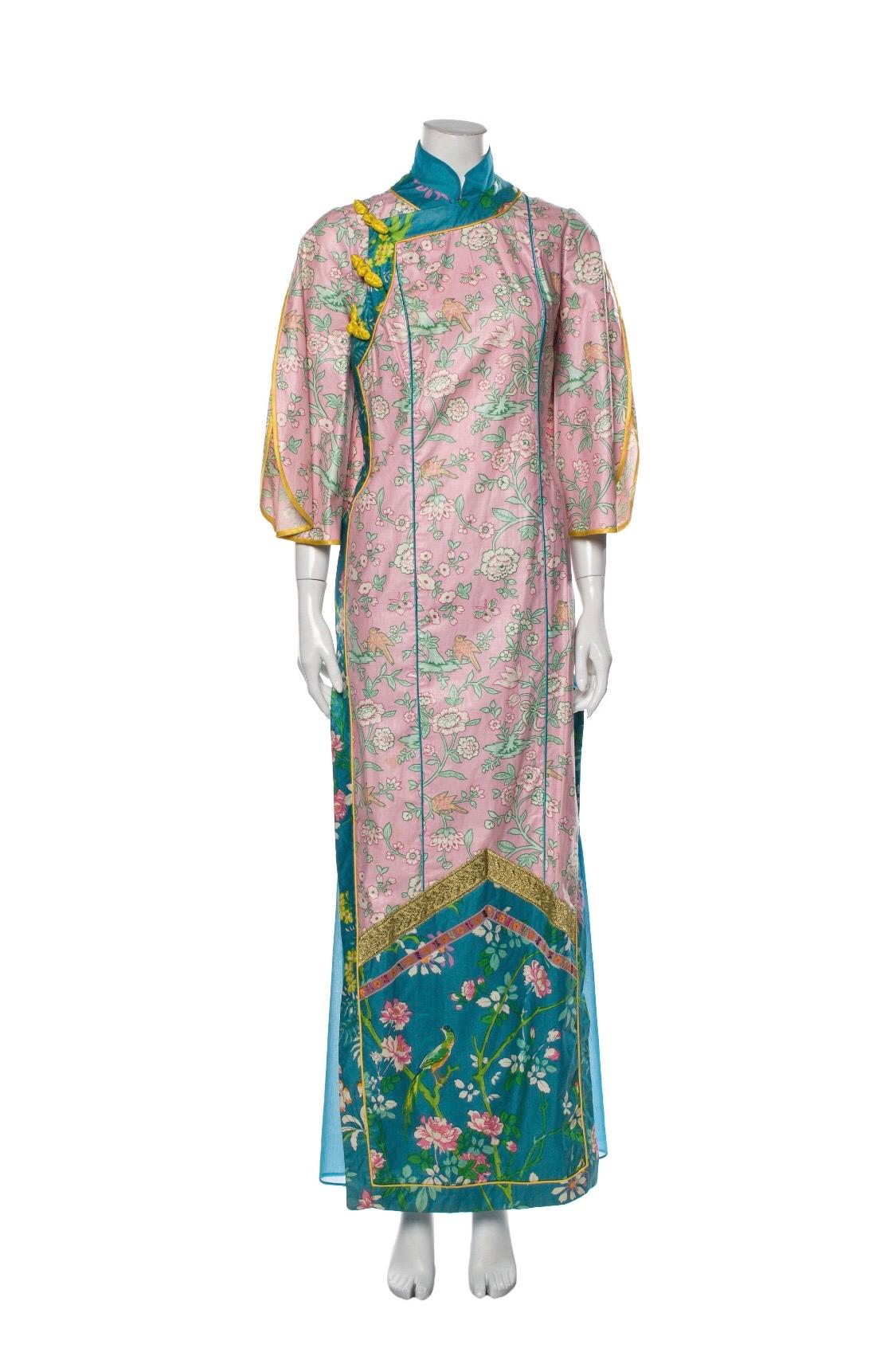 Add a stunning new piece to your wardrobe with this Giorgio di Sant' Angelo for Saks Fifth Avenue dress! Circa 1970s, this colorful kimono dress features multiple contrasting Asian inspired motifs, a blue slip skirt, Mandarin collar, slits on both